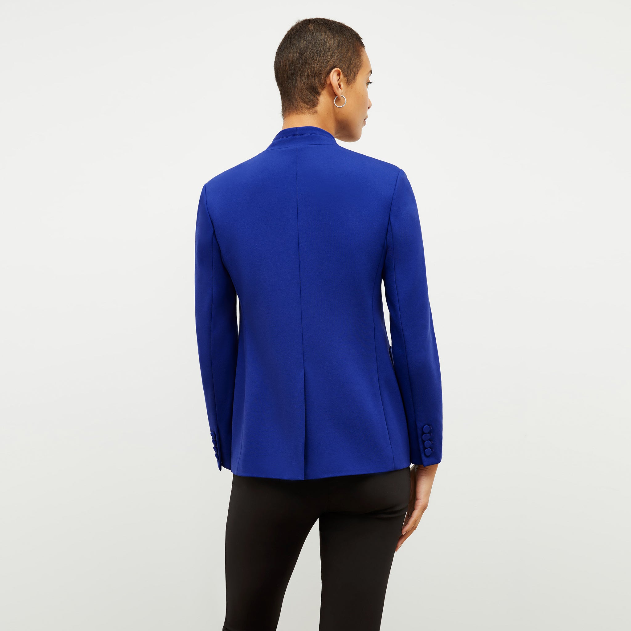 back image of a woman wearing the janette jacket in electric blue