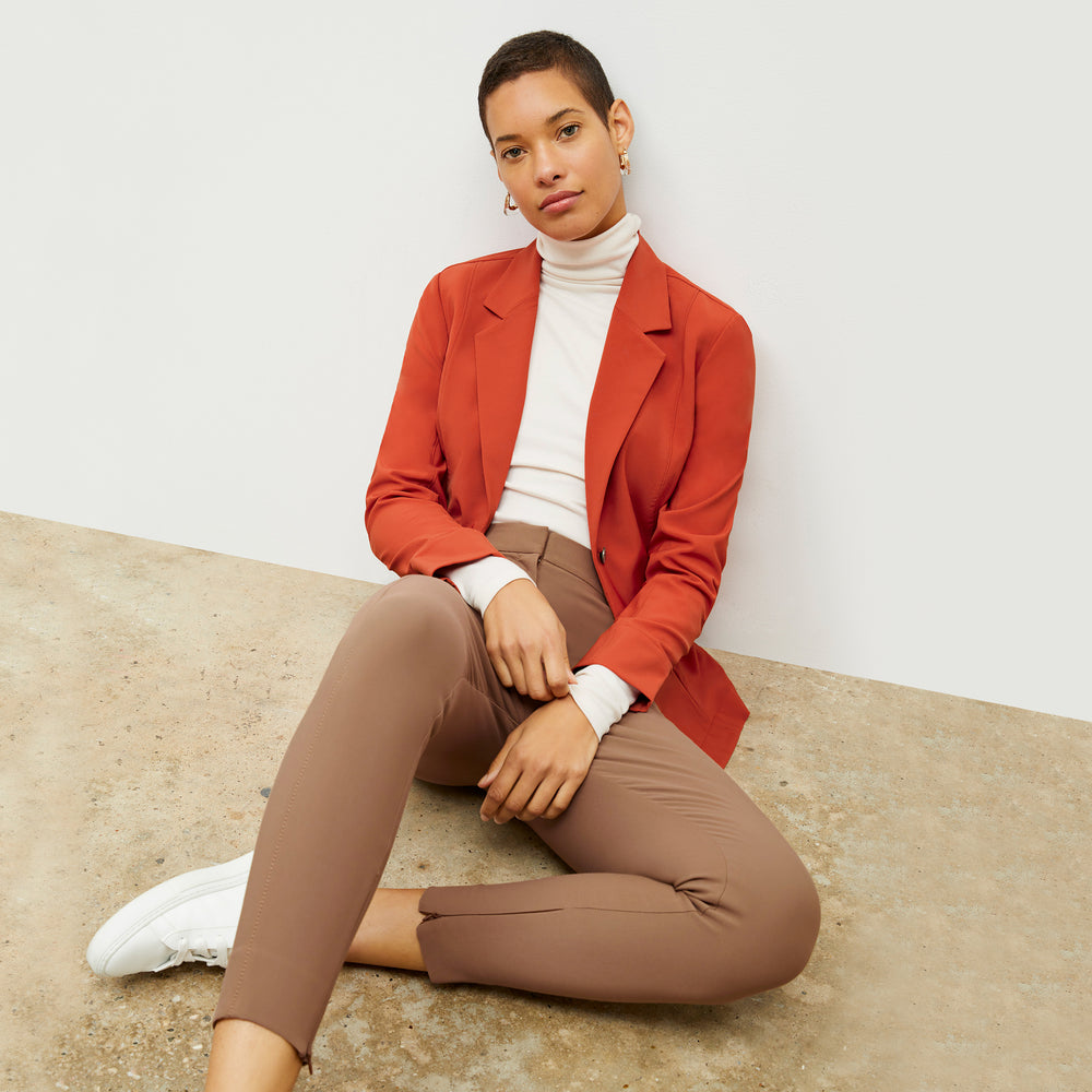 Front image of a woman standing wearing the Curie Pant—Everstretch in Saddle