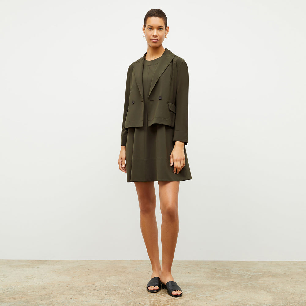 Front image of a woman wearing the nia jacket in olive