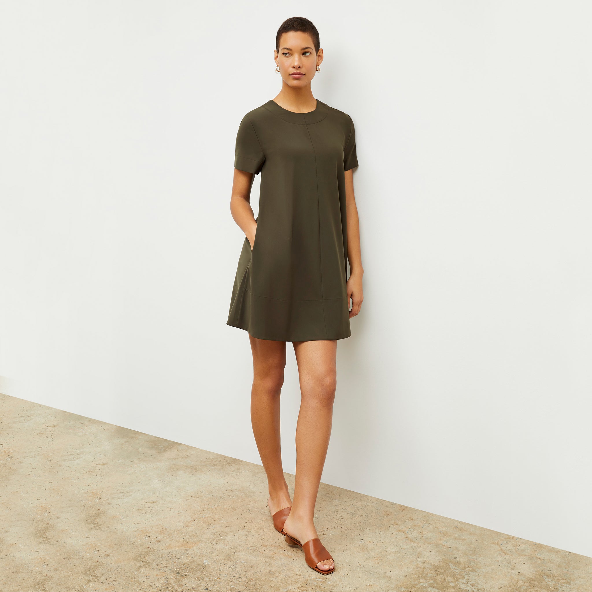 Front image of a woman wearing the Corrie Dress in Olive