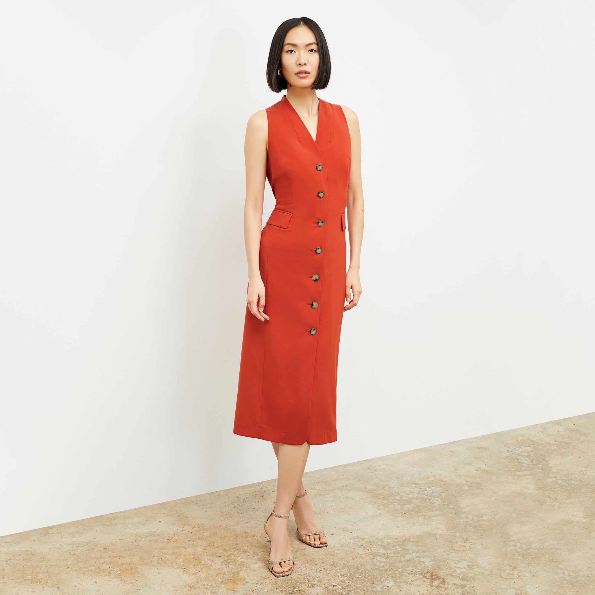 Front image of a woman wearing the Cassandra Dress in Blood Orange 