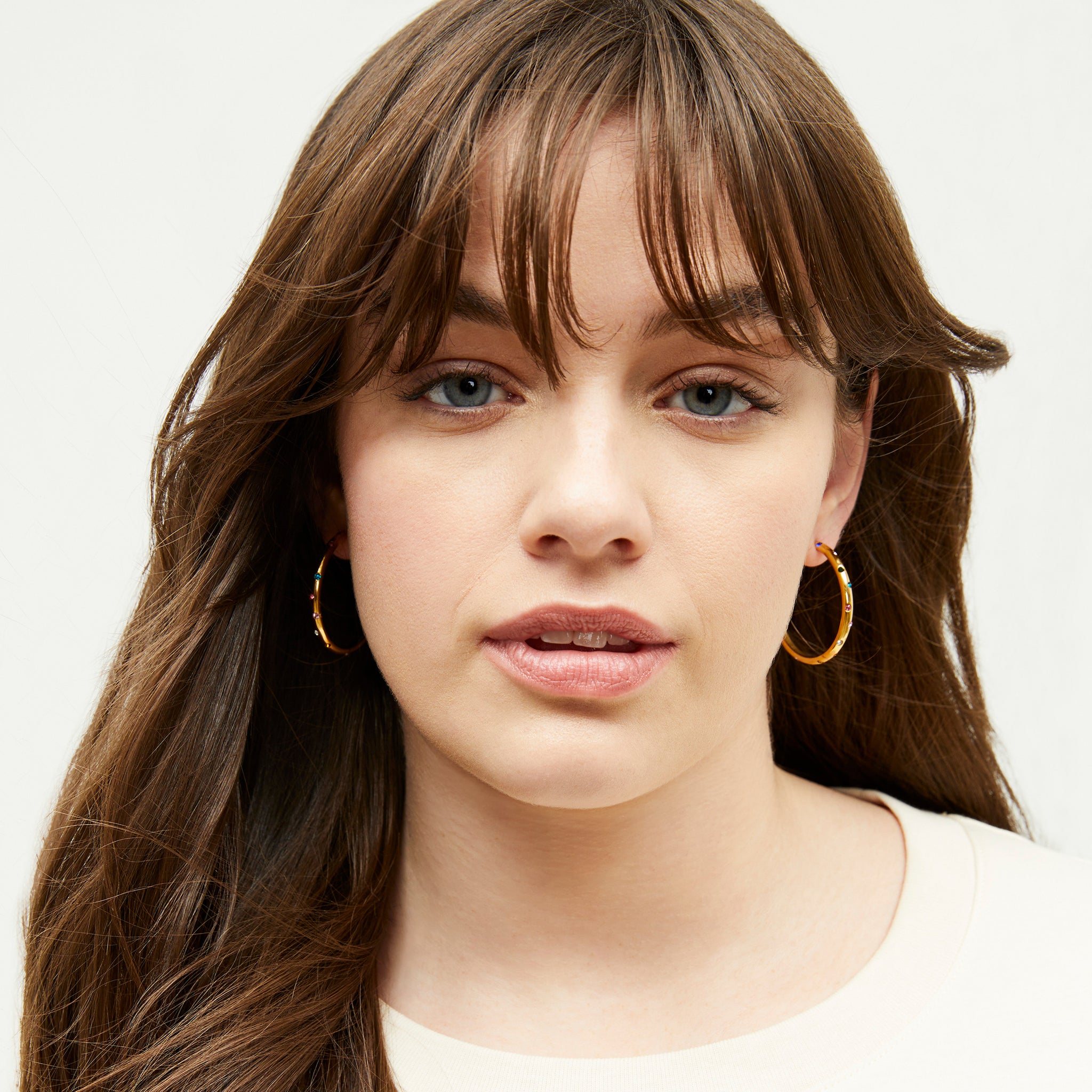 Image of a woman wearing the Ivy earrings