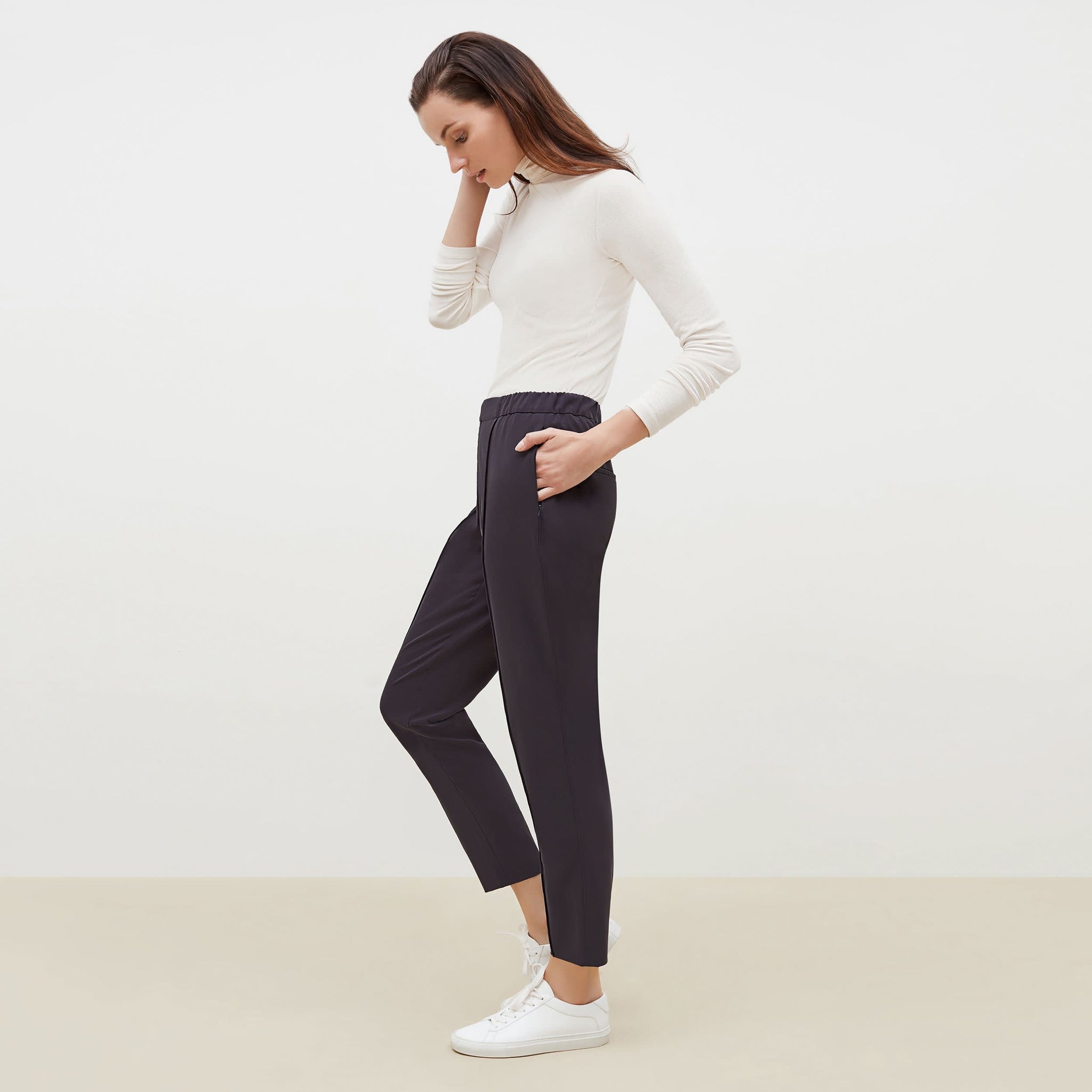 Side image of a woman standing wearing the Colby Jogger in Cool Charcoal 
