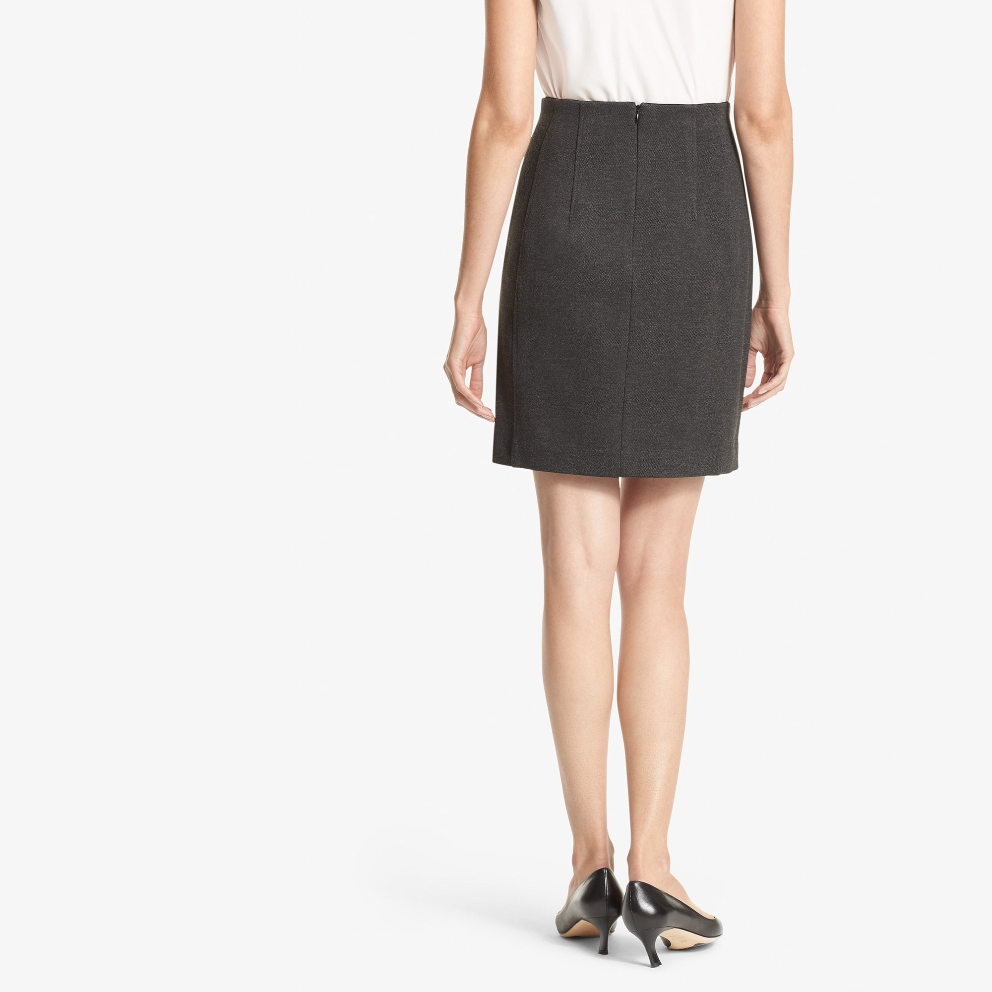 Back image of a woman standing wearing the Crosby skirt textured ponte in Charcoal