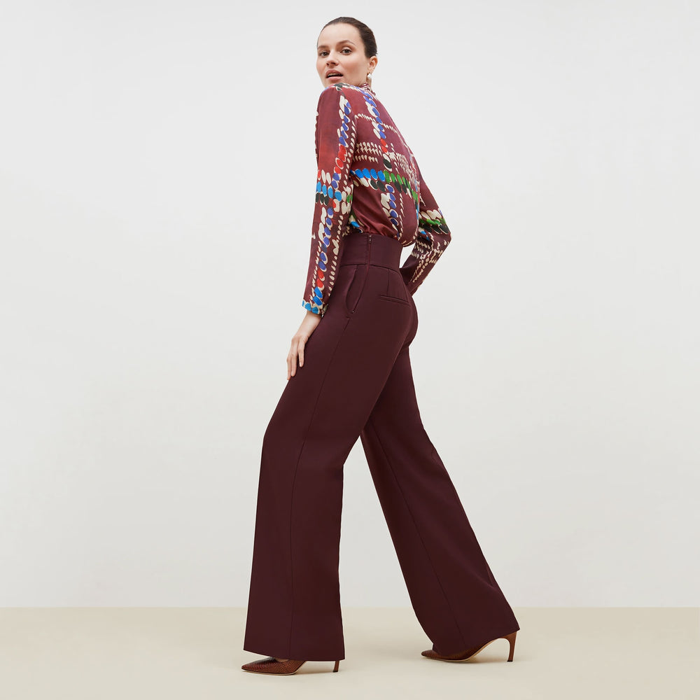 Side image of a woman standing wearing the Hadley Pant-Sharkskin in garnet