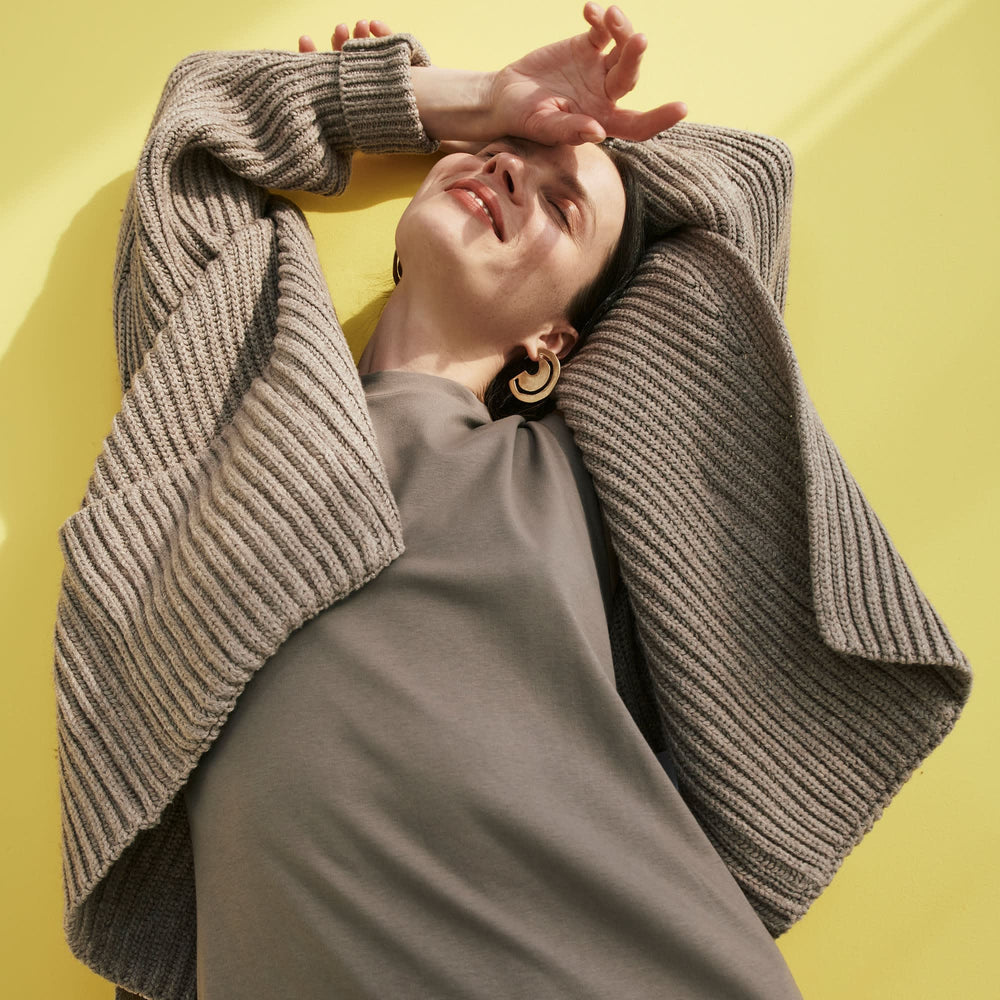 Front image of a woman standing wearing the Snyder Jacket—Lush Merino in Barley