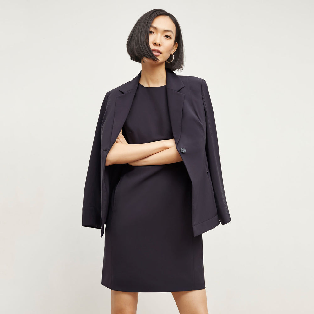 Front image of a woman standing wearing the Moreland Jacket—Origami Suiting in Cool Charcoal