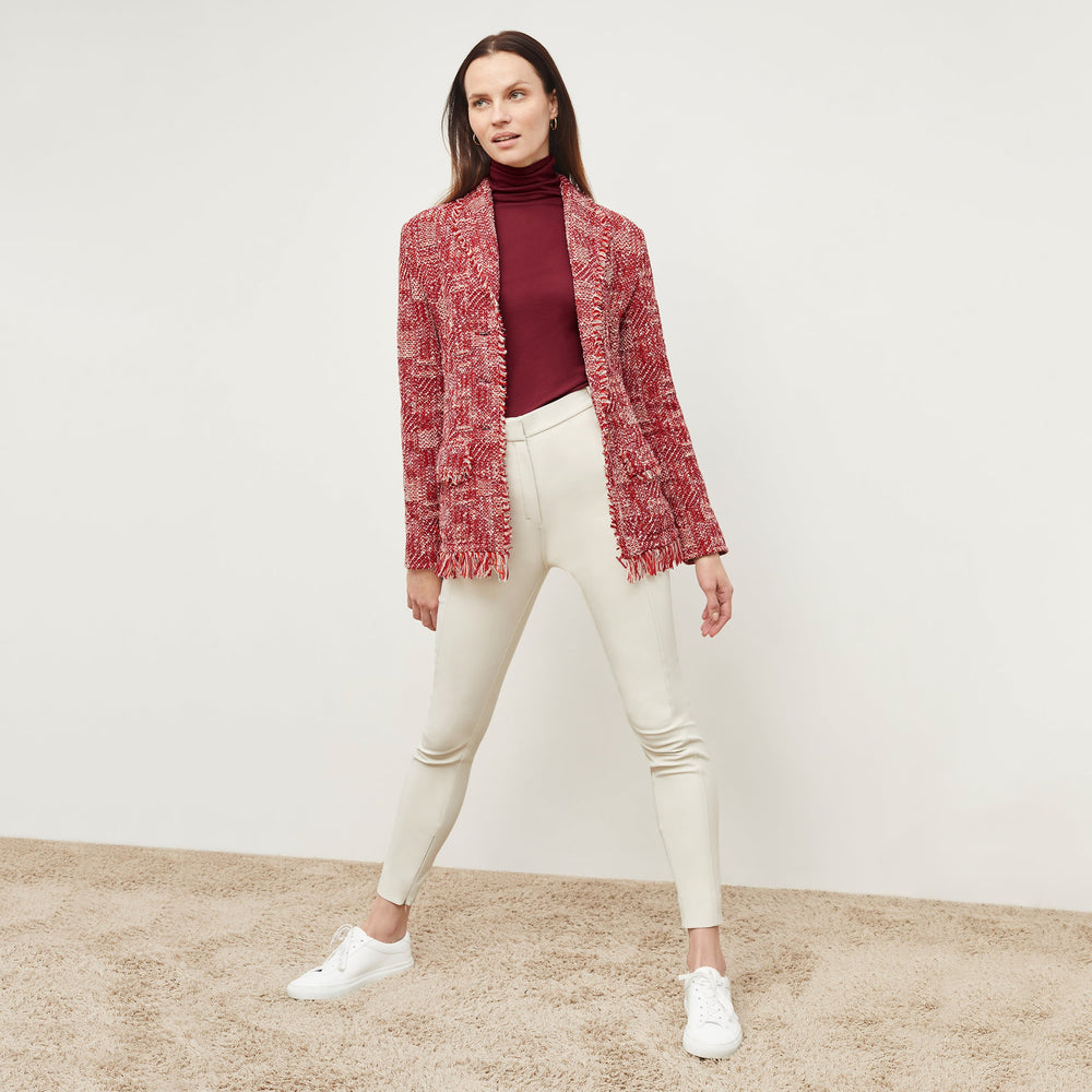 Front image of a woman standing wearing the Porter Jacket—Interweave in Red Multi