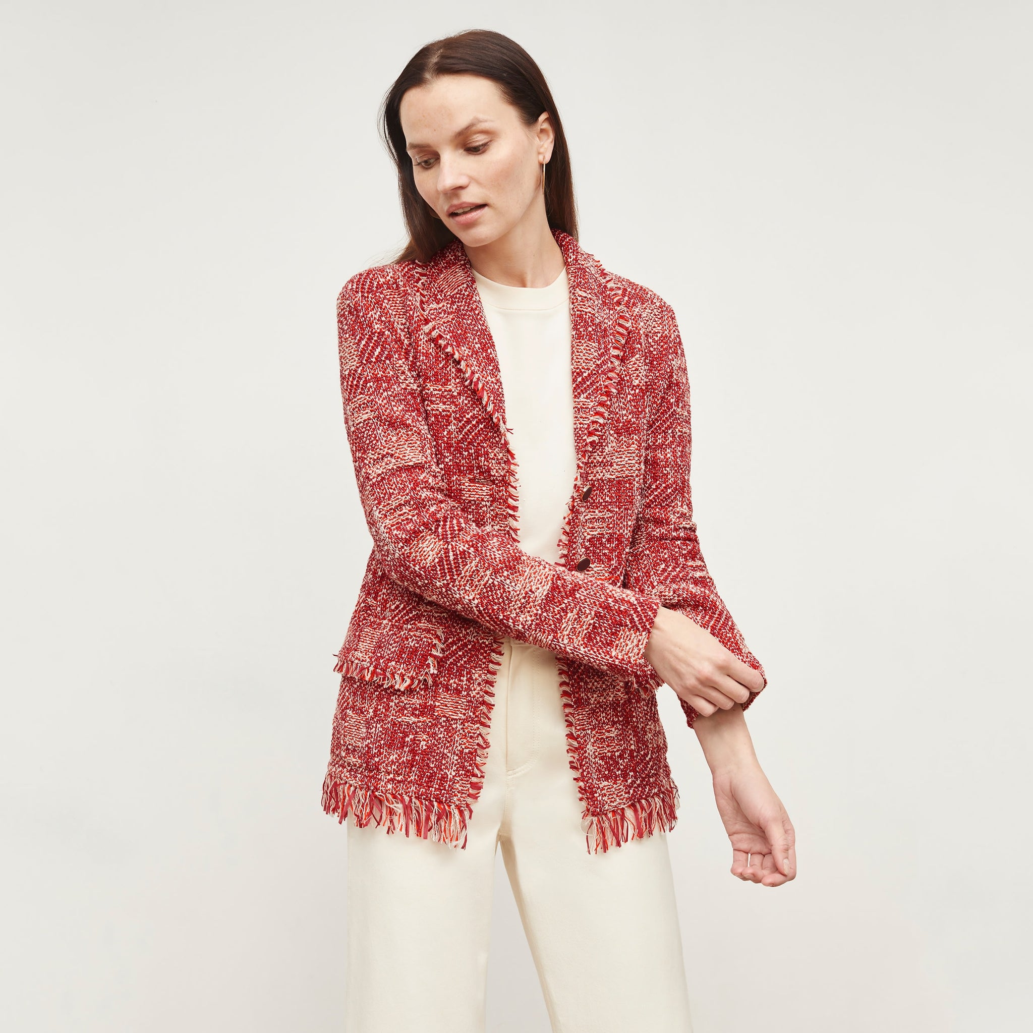 Front image of a woman standing wearing the Porter Jacket—Interweave in Red Multi  