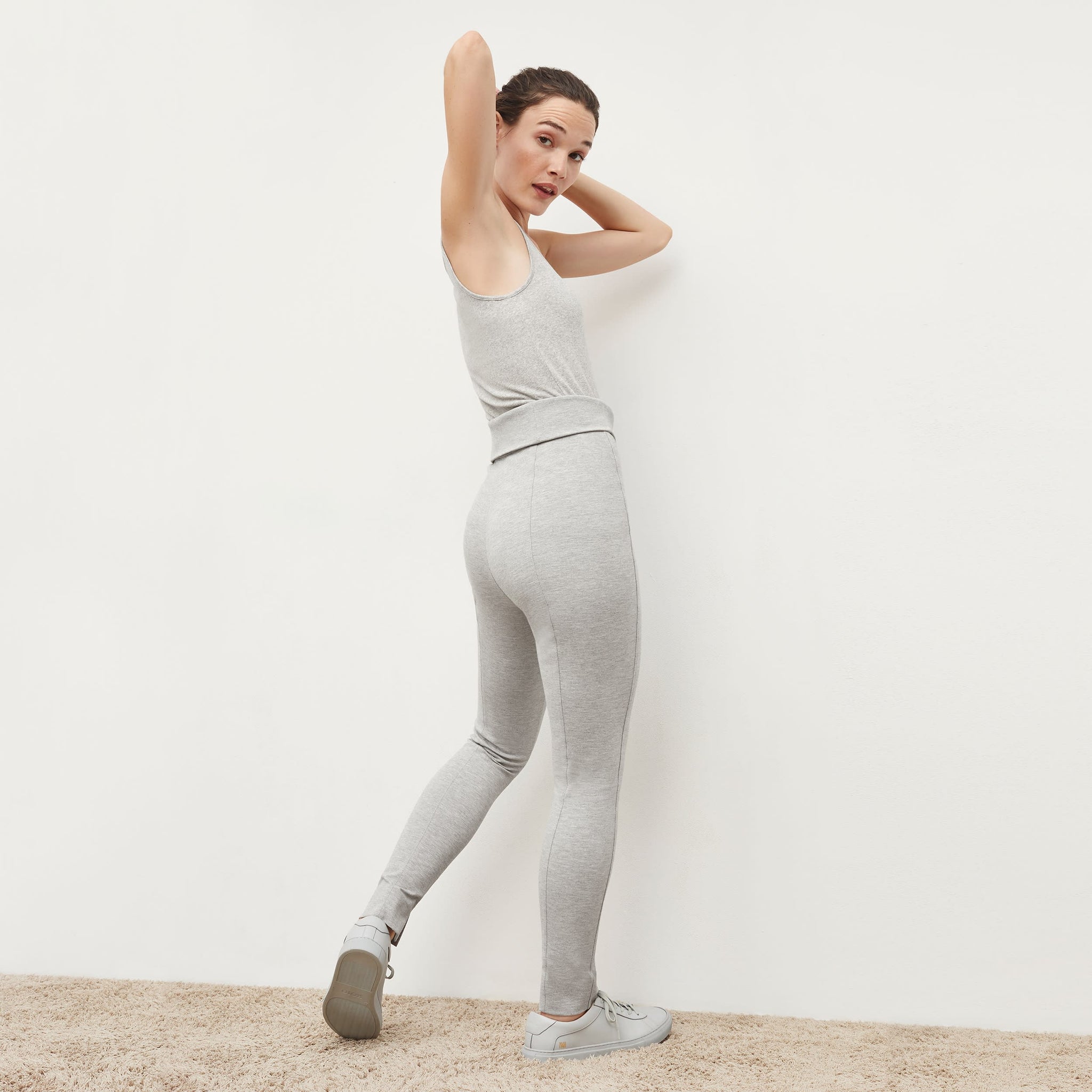 Back image of a woman standing wearing the Stella Legging in Gray Melange