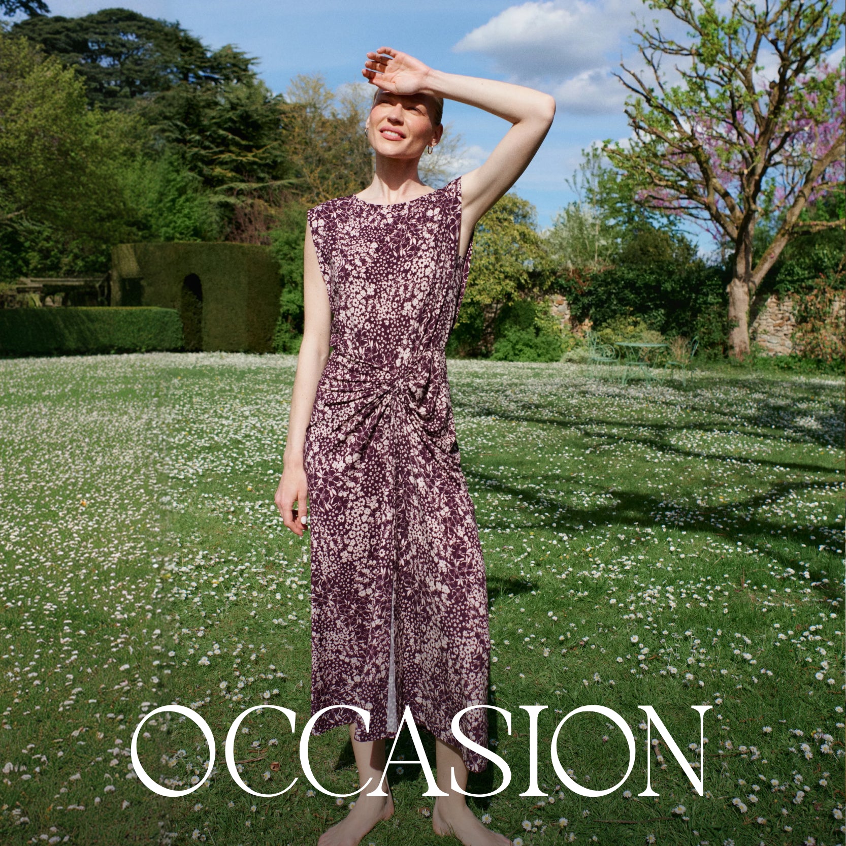 Woman in a purple dress standing in a garden with 'OCCASION' branding.
