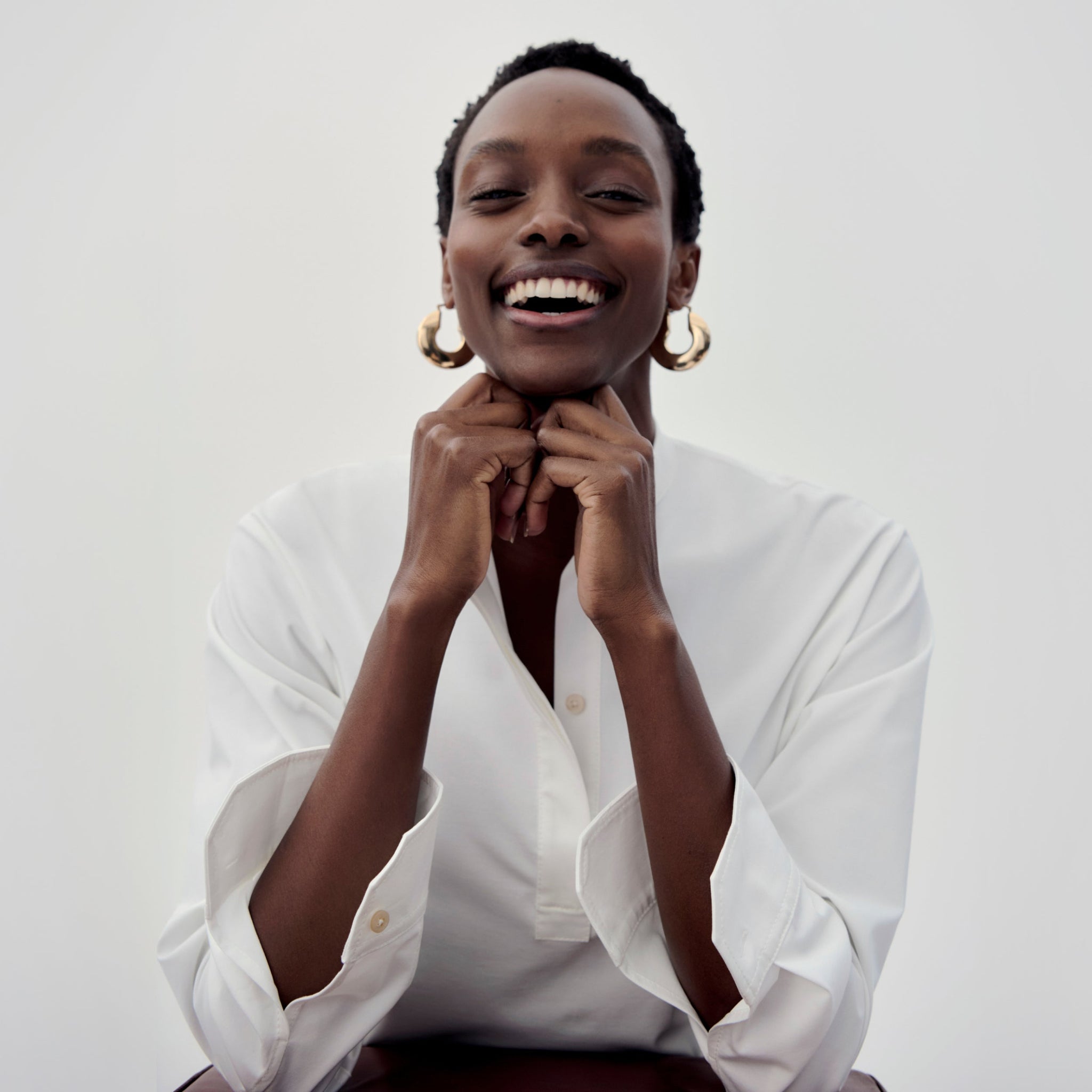 Image of a woman wearing the Tonya top and Lennon earrings 