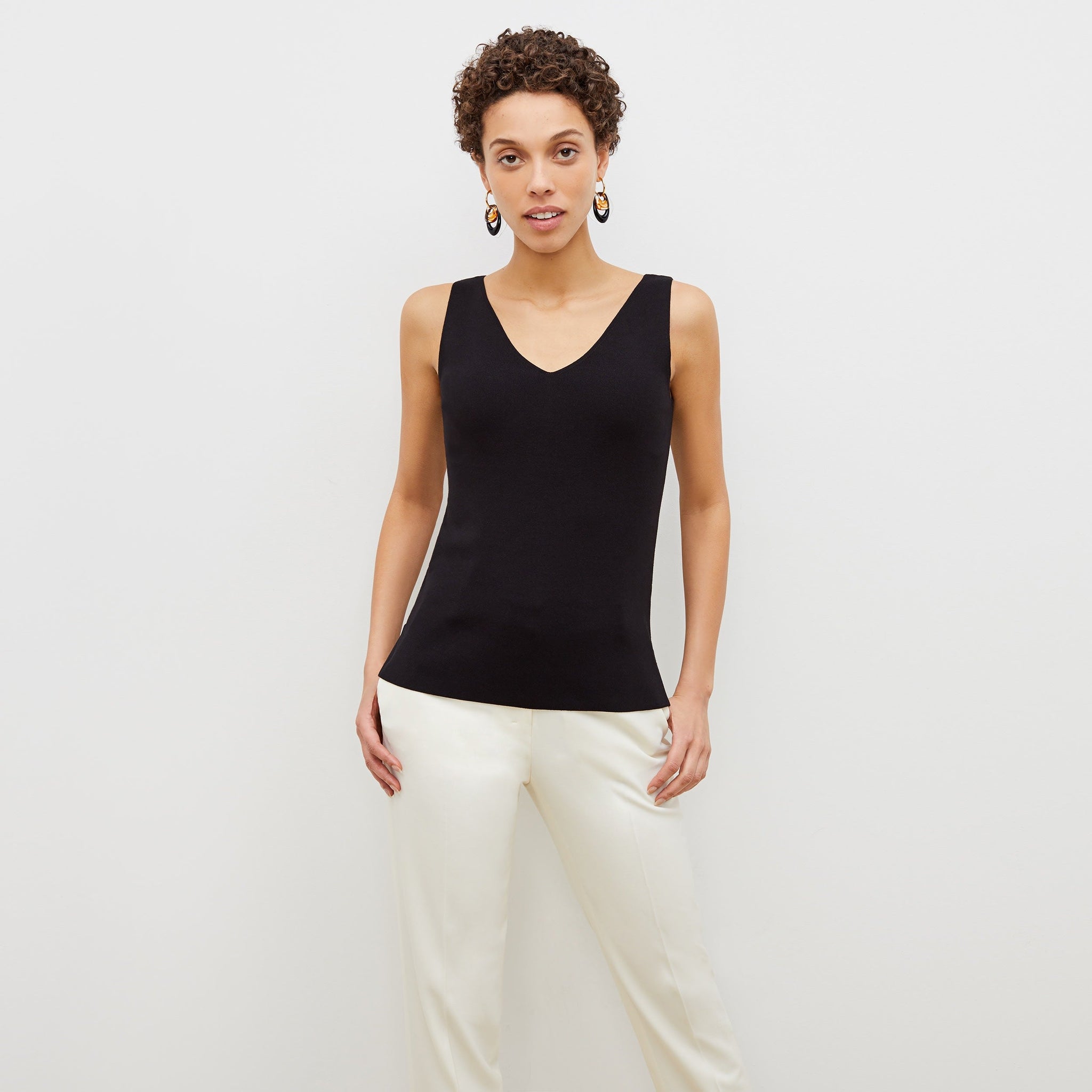 front image of a woman wearing the peggy top in black