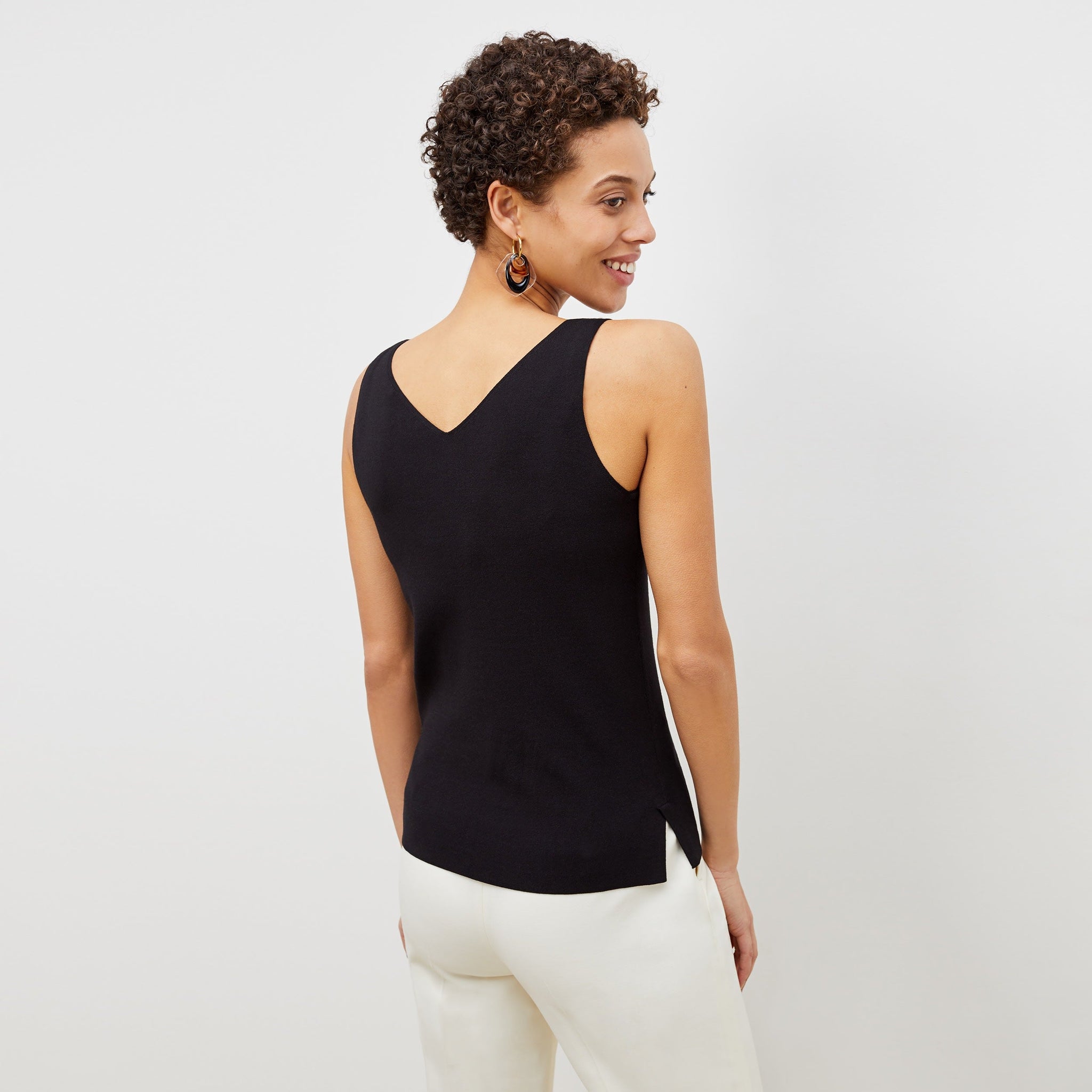 back image of a woman wearing the peggy top in black