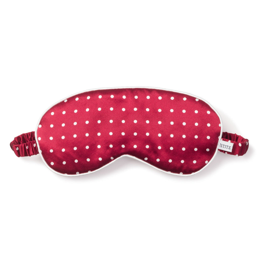 Red sleep mask with white polka dots on a white background