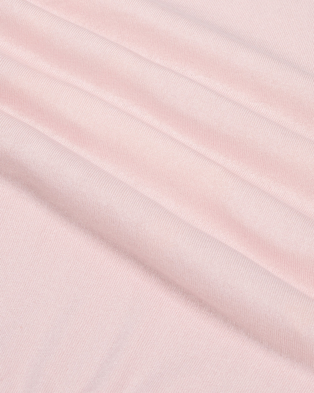 Close-up of light pink fabric with subtle texture.
