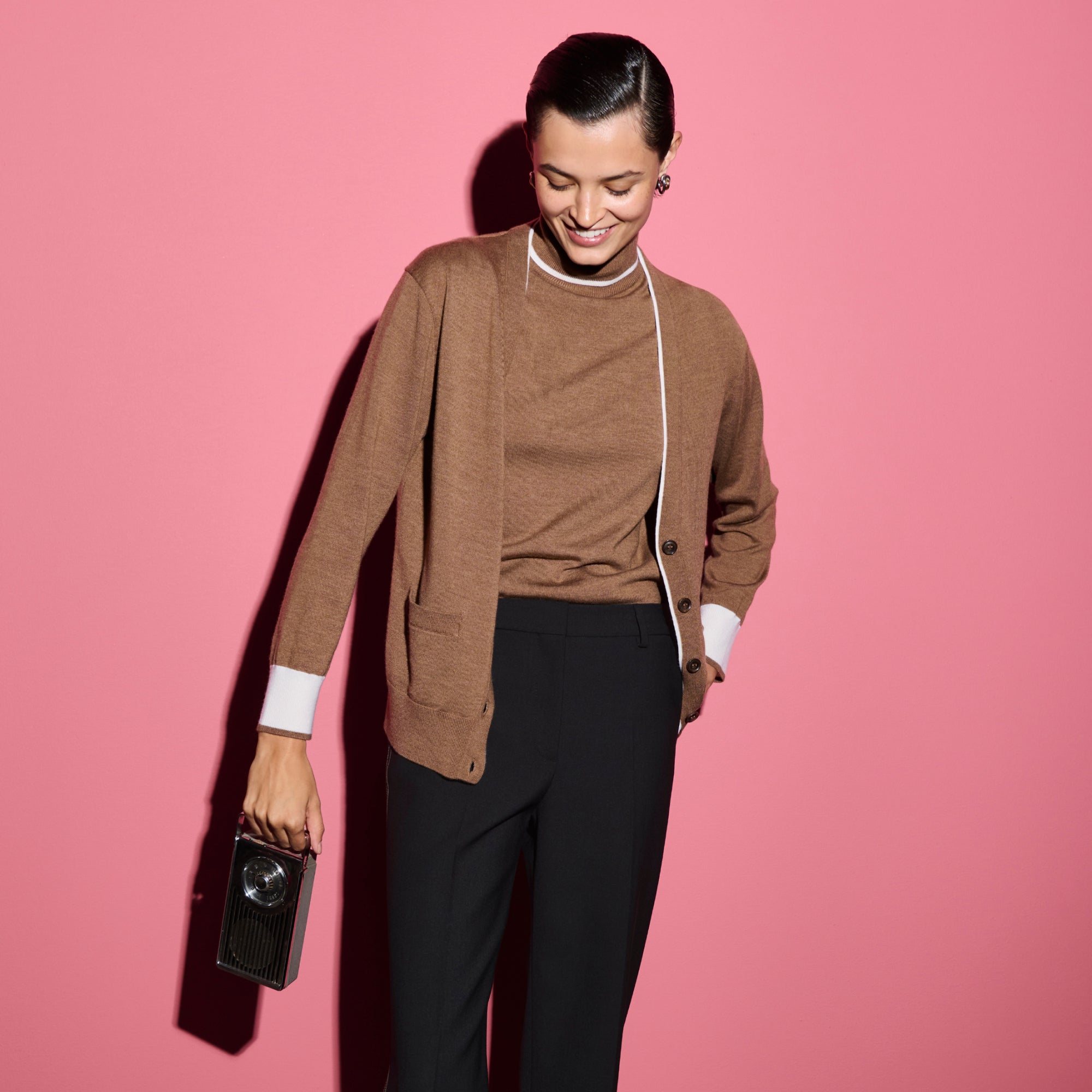 front image of a woman wearing the cookie cardigan in camel/ivory