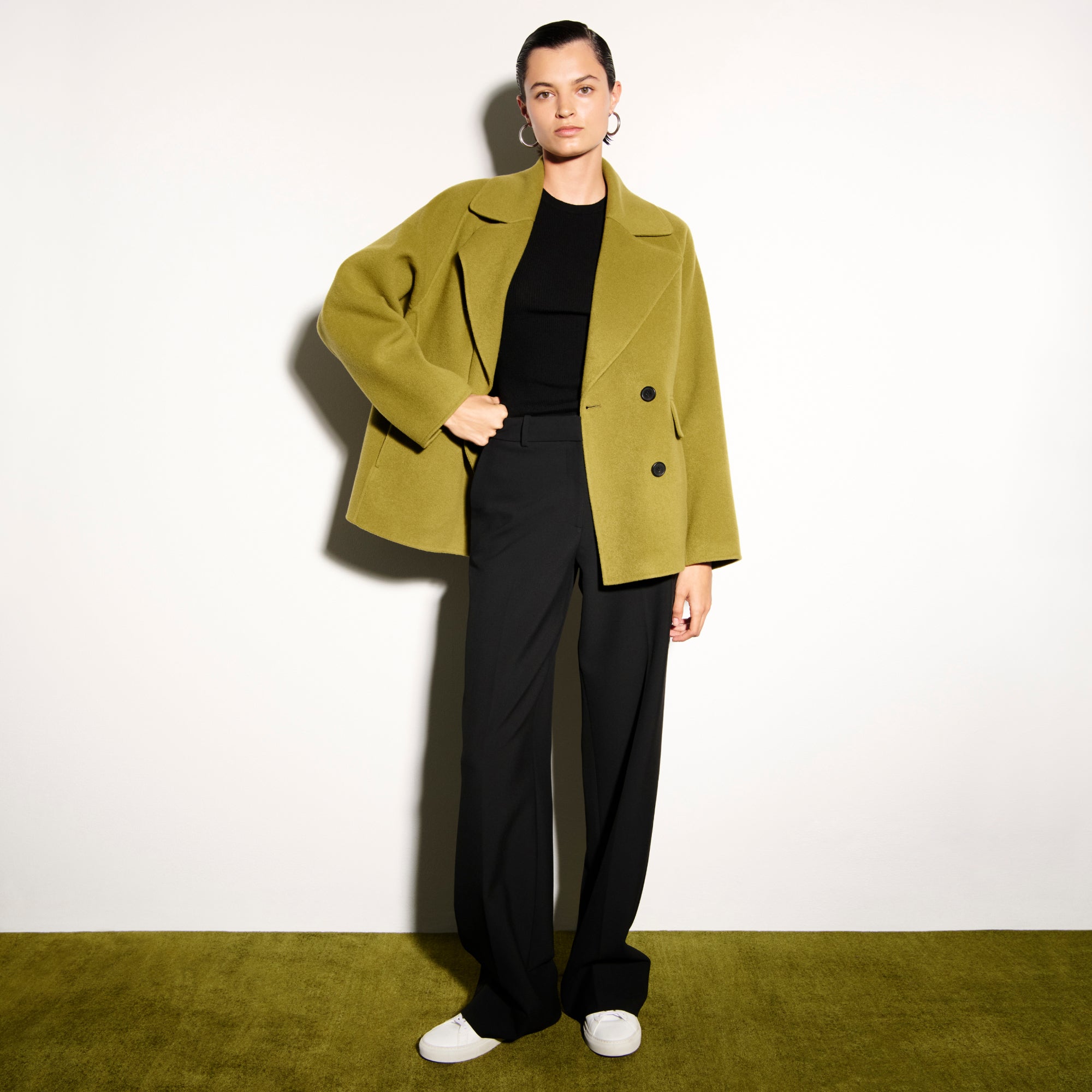 front image of a woman wearing the calista coat in pistachio