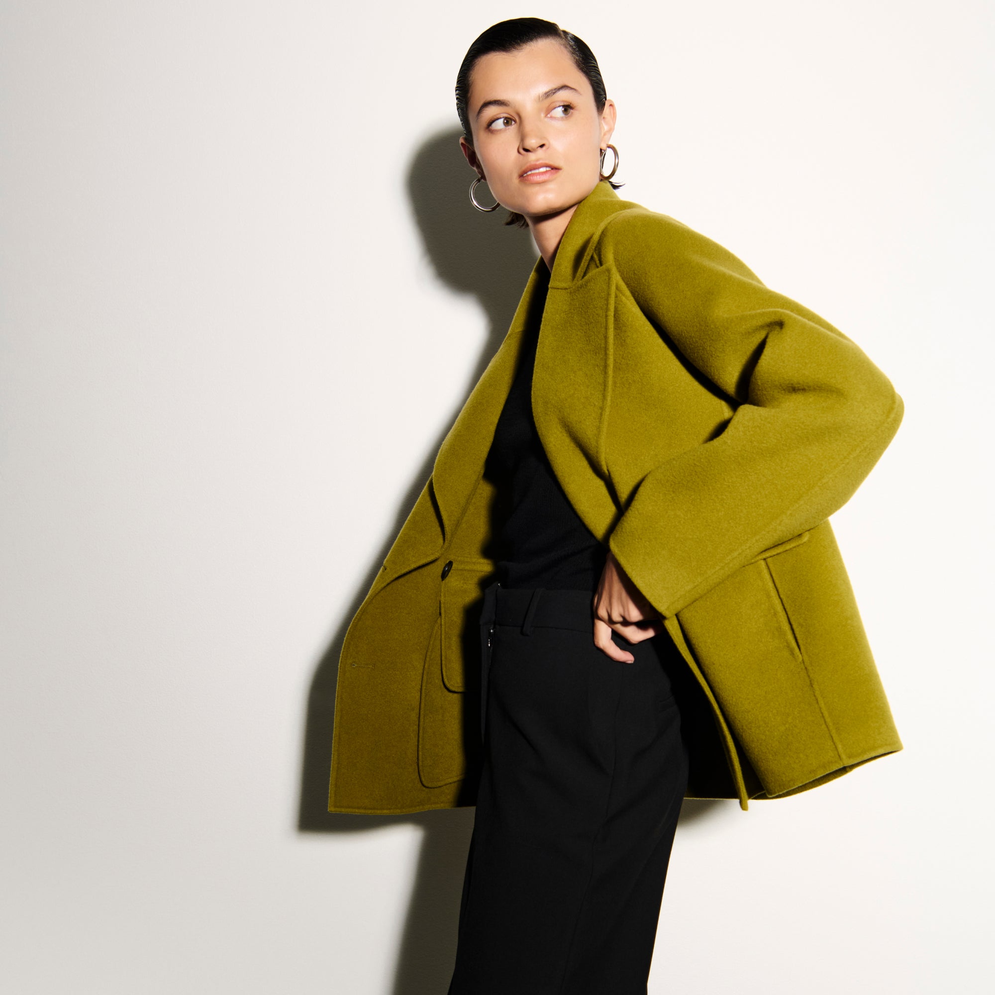 front image of a woman wearing the calista coat in pistachio