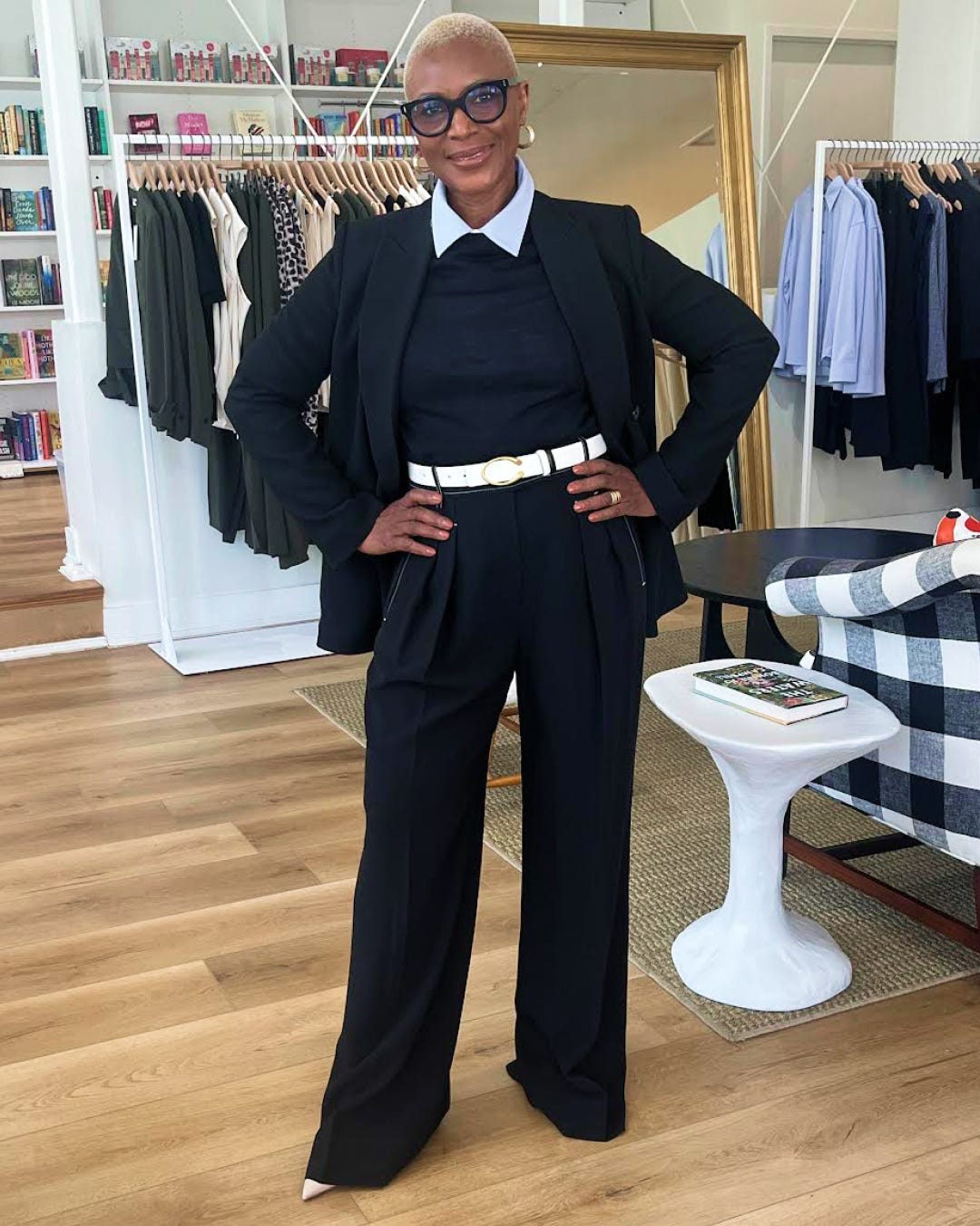 Person wearing a black suit in a clothing store