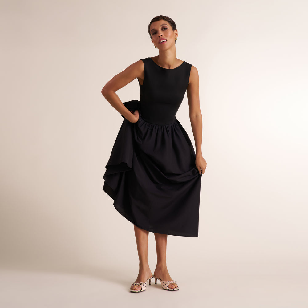 Woman wearing a sleeveless black maxi dress
