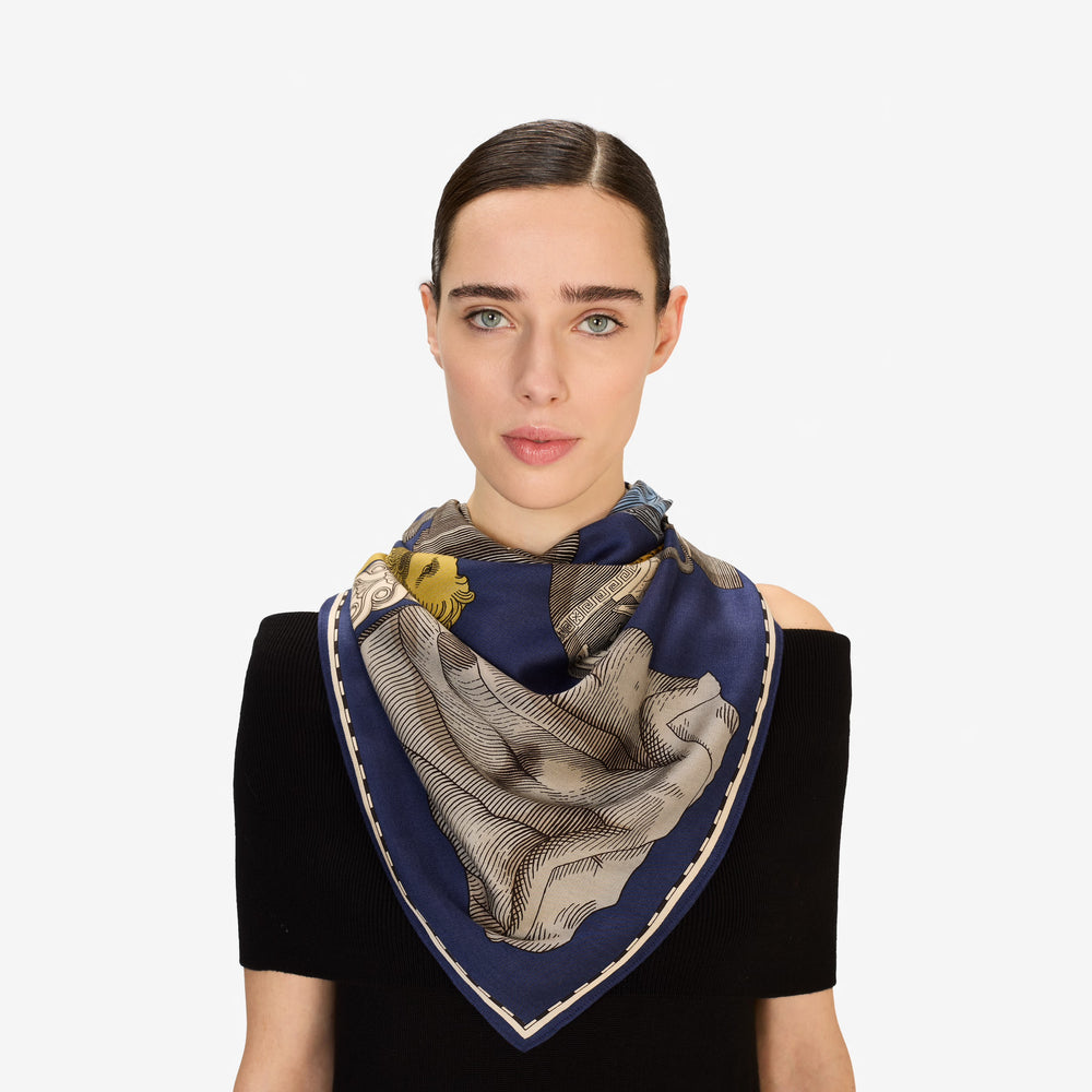 Woman wearing a patterned scarf on a white background