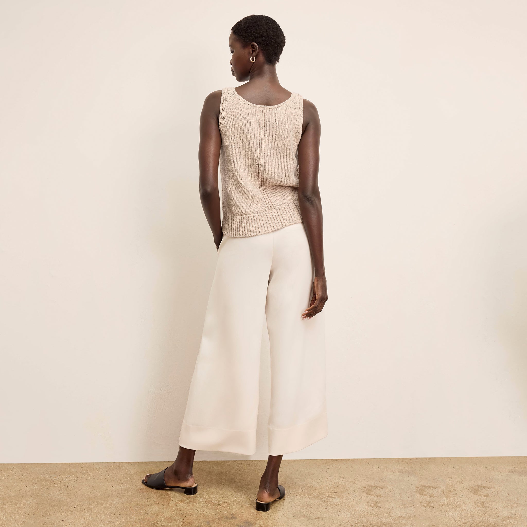 Back image of a woman wearing the Aiko Top in Tan