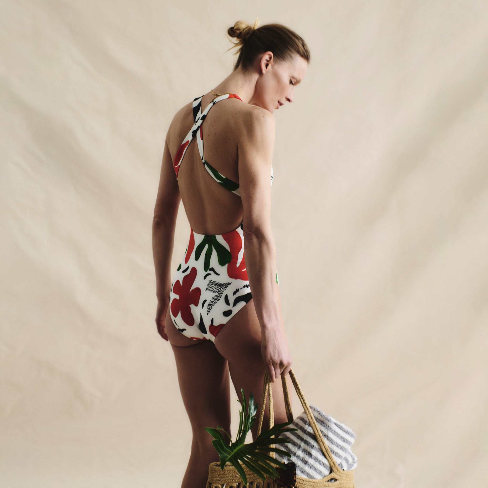 image of a woman wearing the M.M.LaFleurxAndie Tulum One Piece in cutout floral
