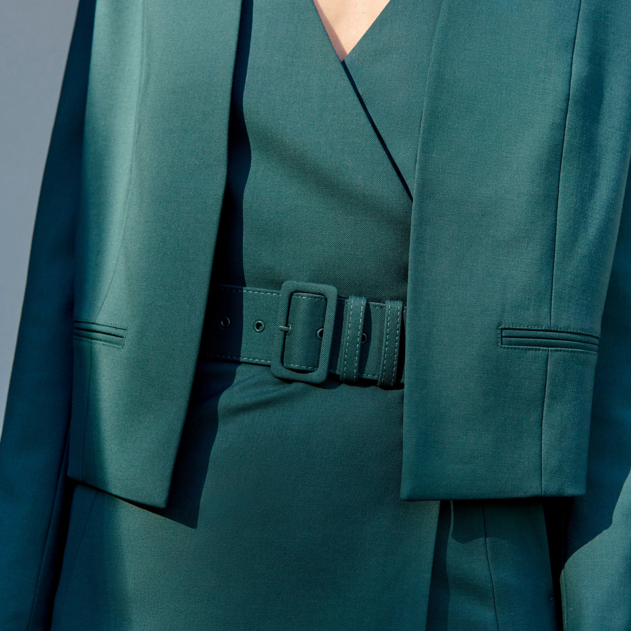 front image of a woman wearing the neale jacket in blue jade