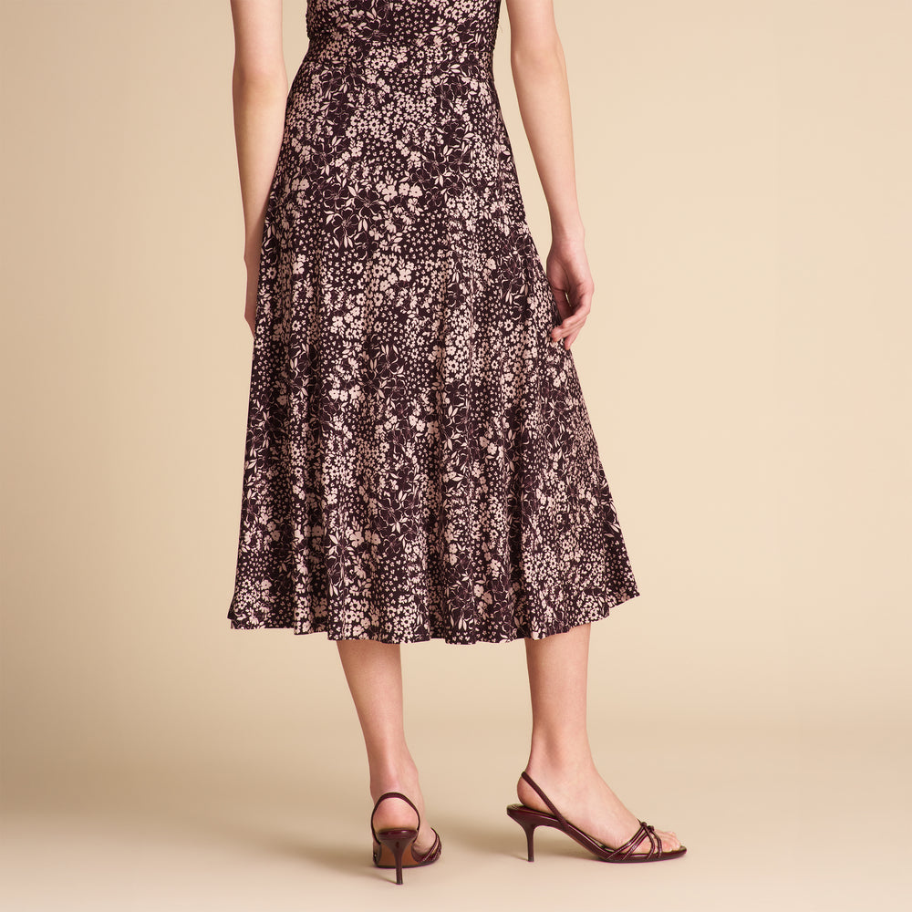 Woman wearing a floral dress on a beige background