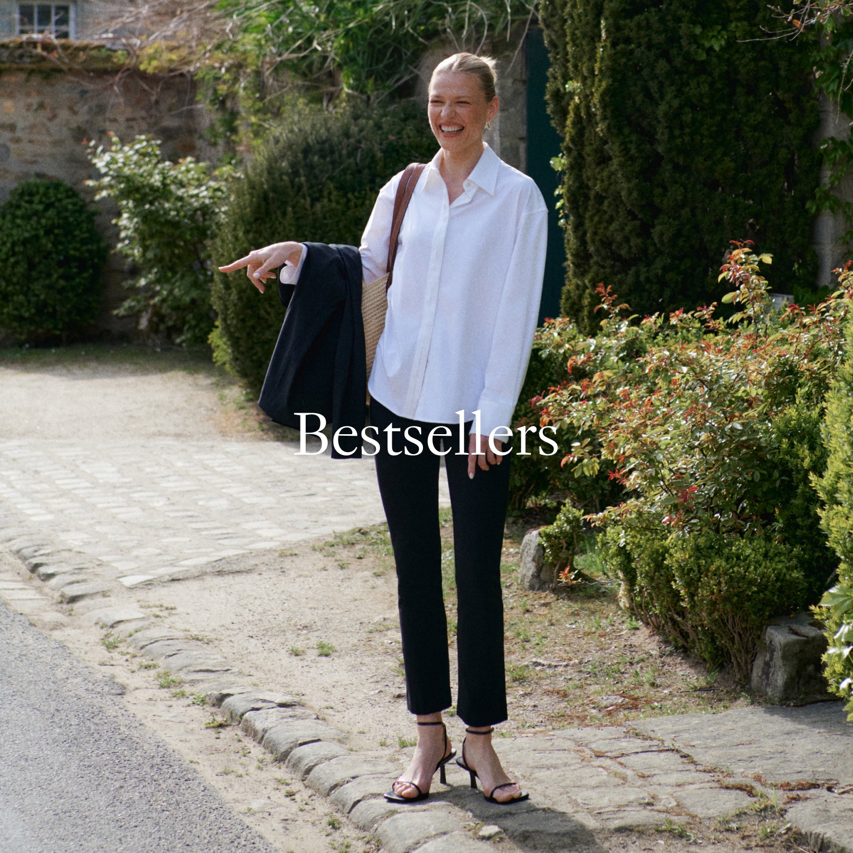 image of a woman wearing a white button down and black cigarette pants with the word "Bestsellers" baked in