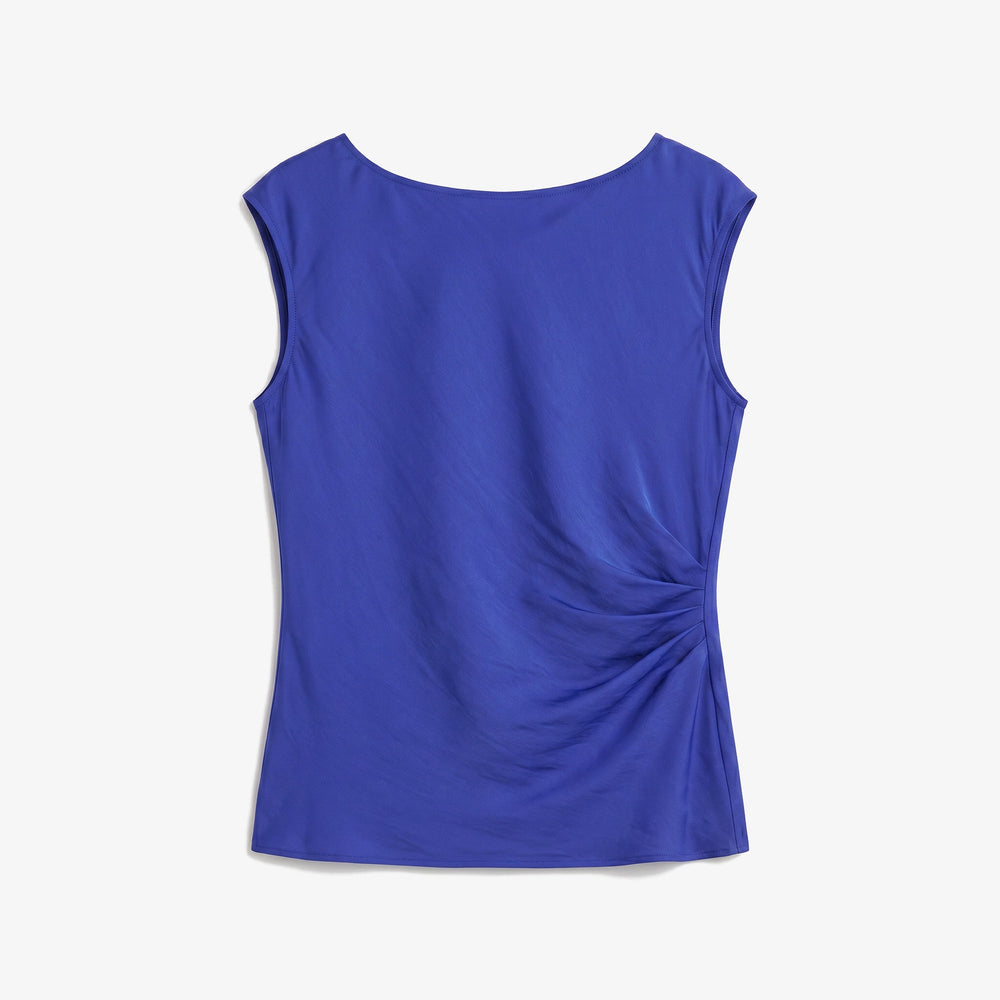 A sleeveless royal blue top with a draped, gathered design on the right side, displayed flat against a light gray background.