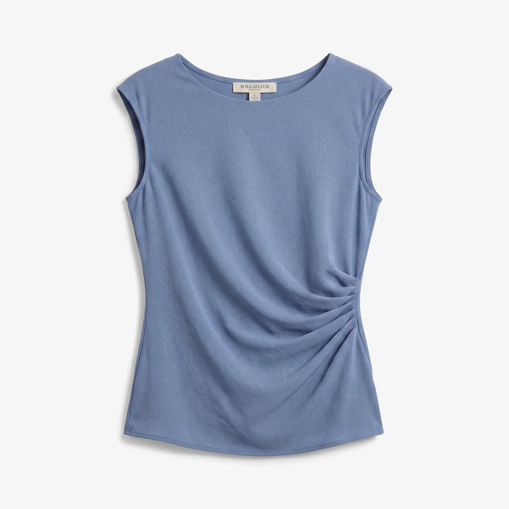 A sleeveless dusty blue top with a gathered side detail, shown flat against a light gray background.