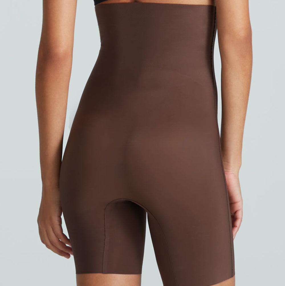 Brown high-waisted shorts worn by a person on a light gray background