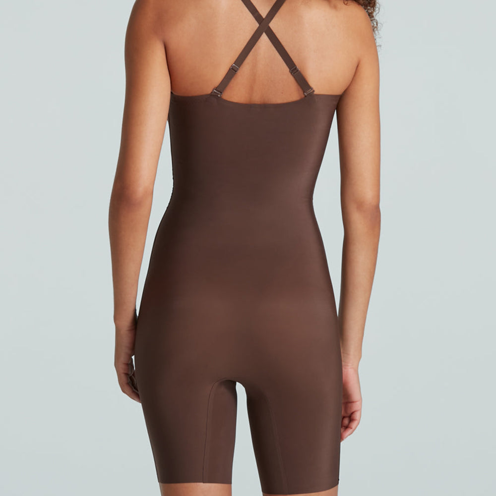 Brown bodysuit worn by a model on a light gray background