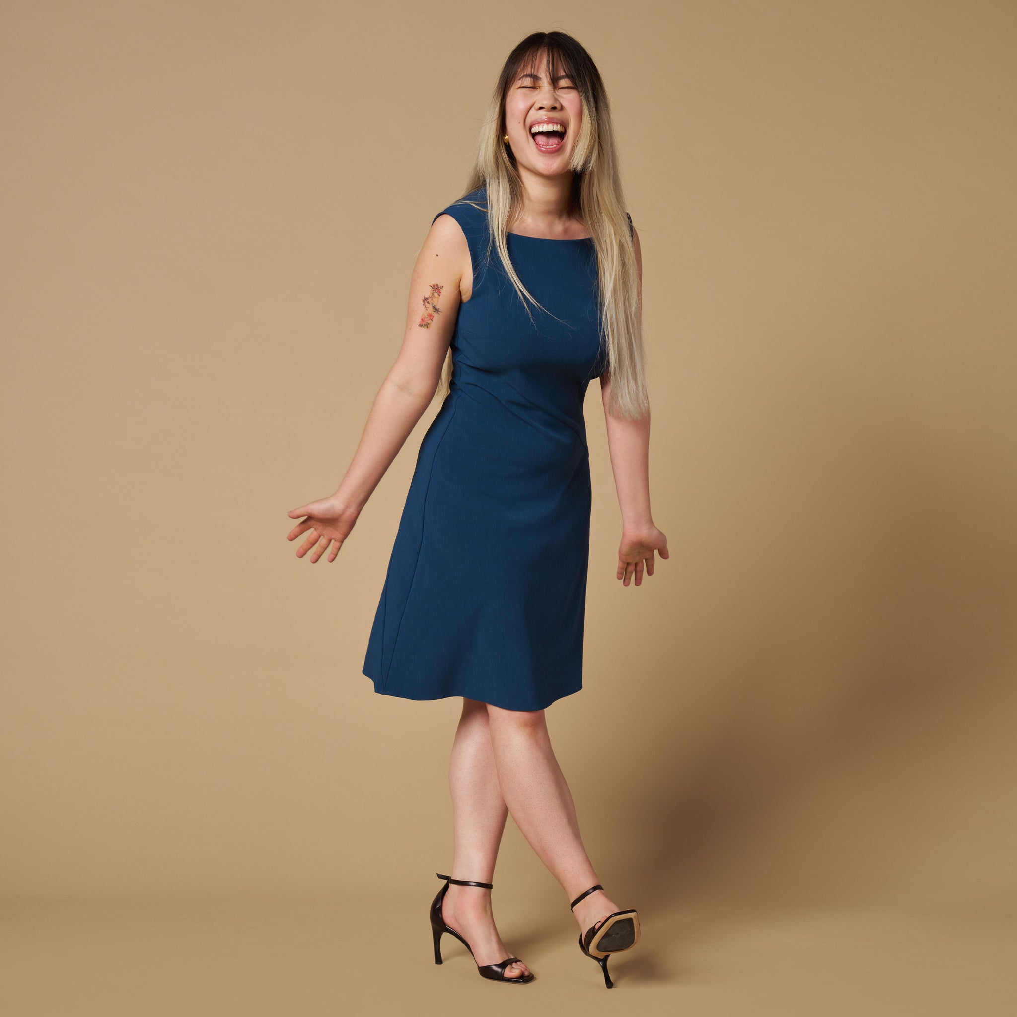 mood image of a woman wearing the pauline dress in deep teal