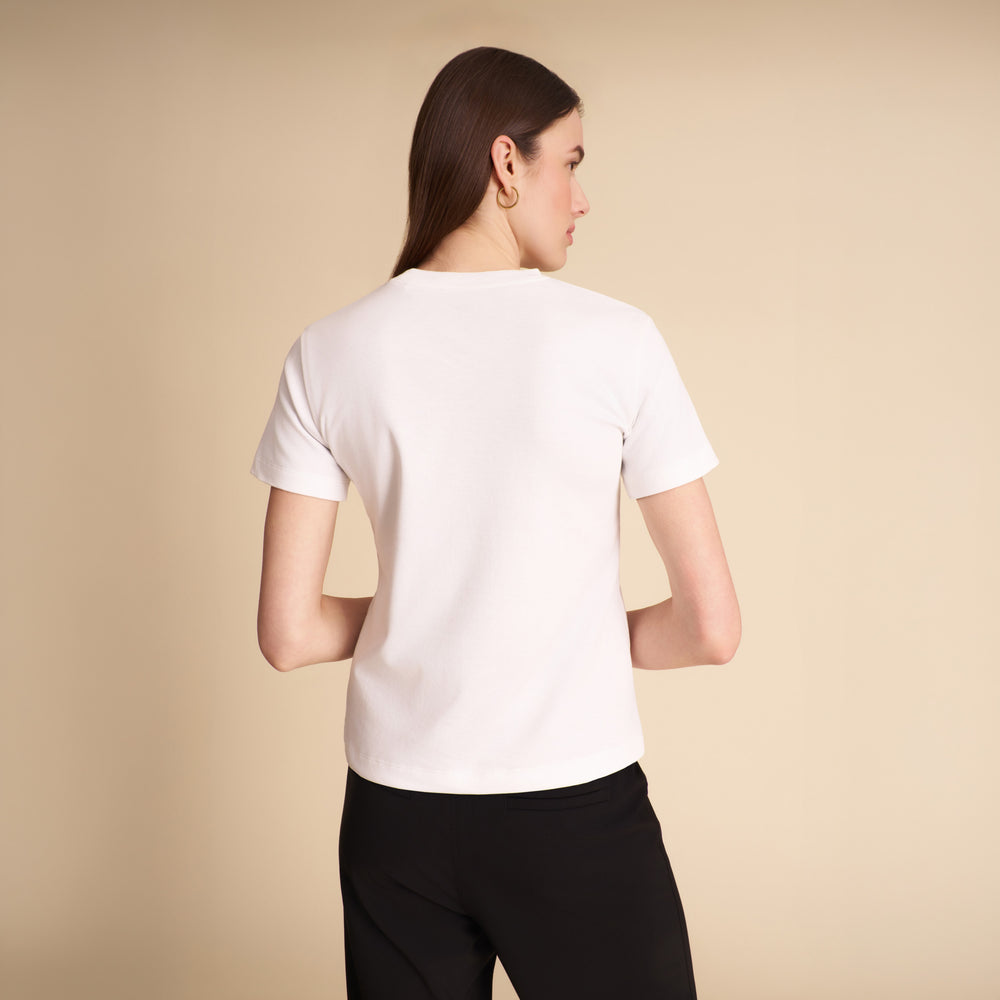 Women wearing the Leslie shirt in white on a beige background