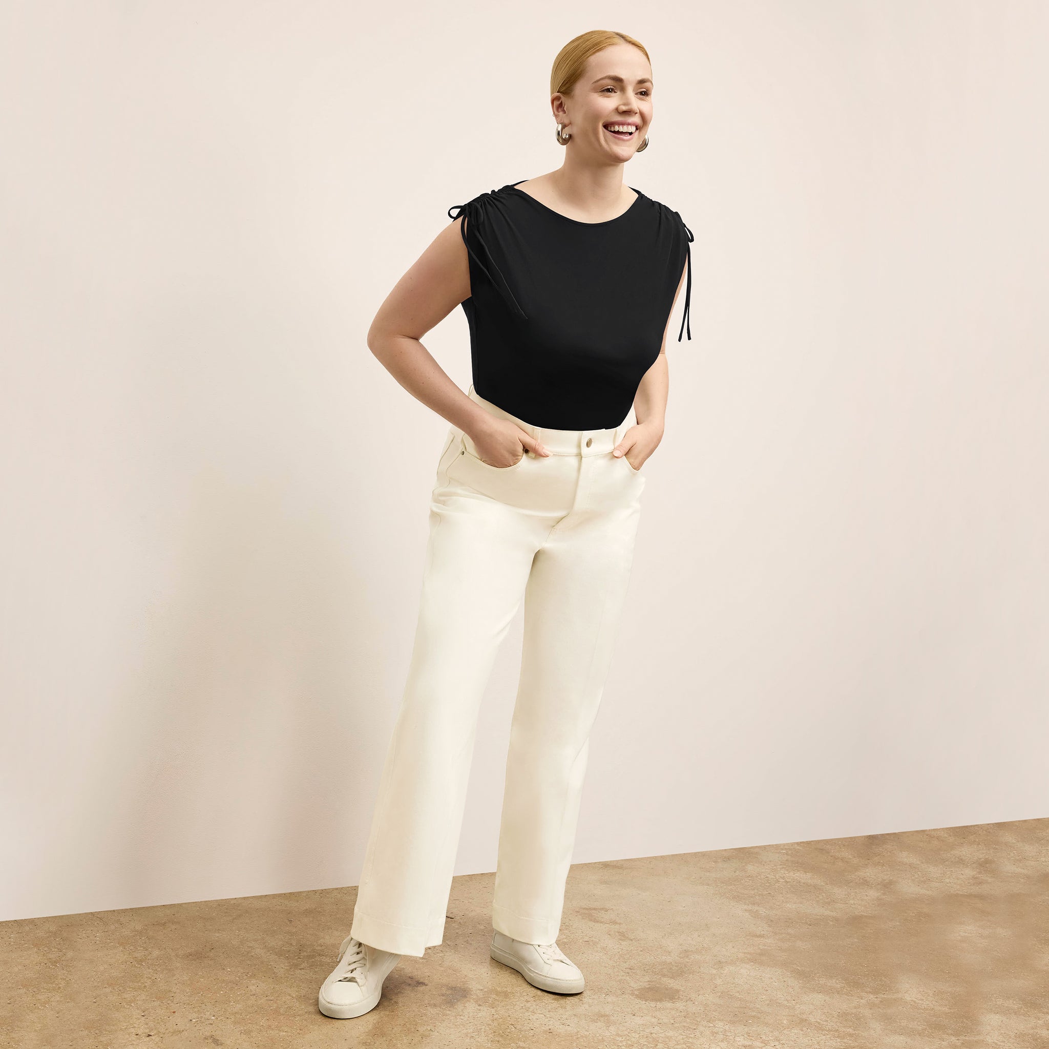 Front image of a woman wearing the Dotty Top in Black