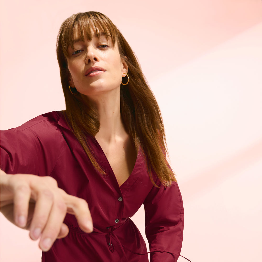 front image of a woman wearing the boden dress in cinnabar