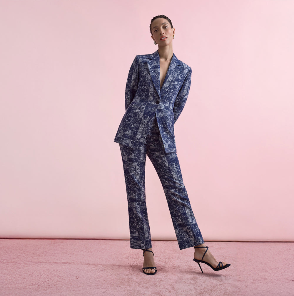Floral-patterned pants worn by a person on a beige background