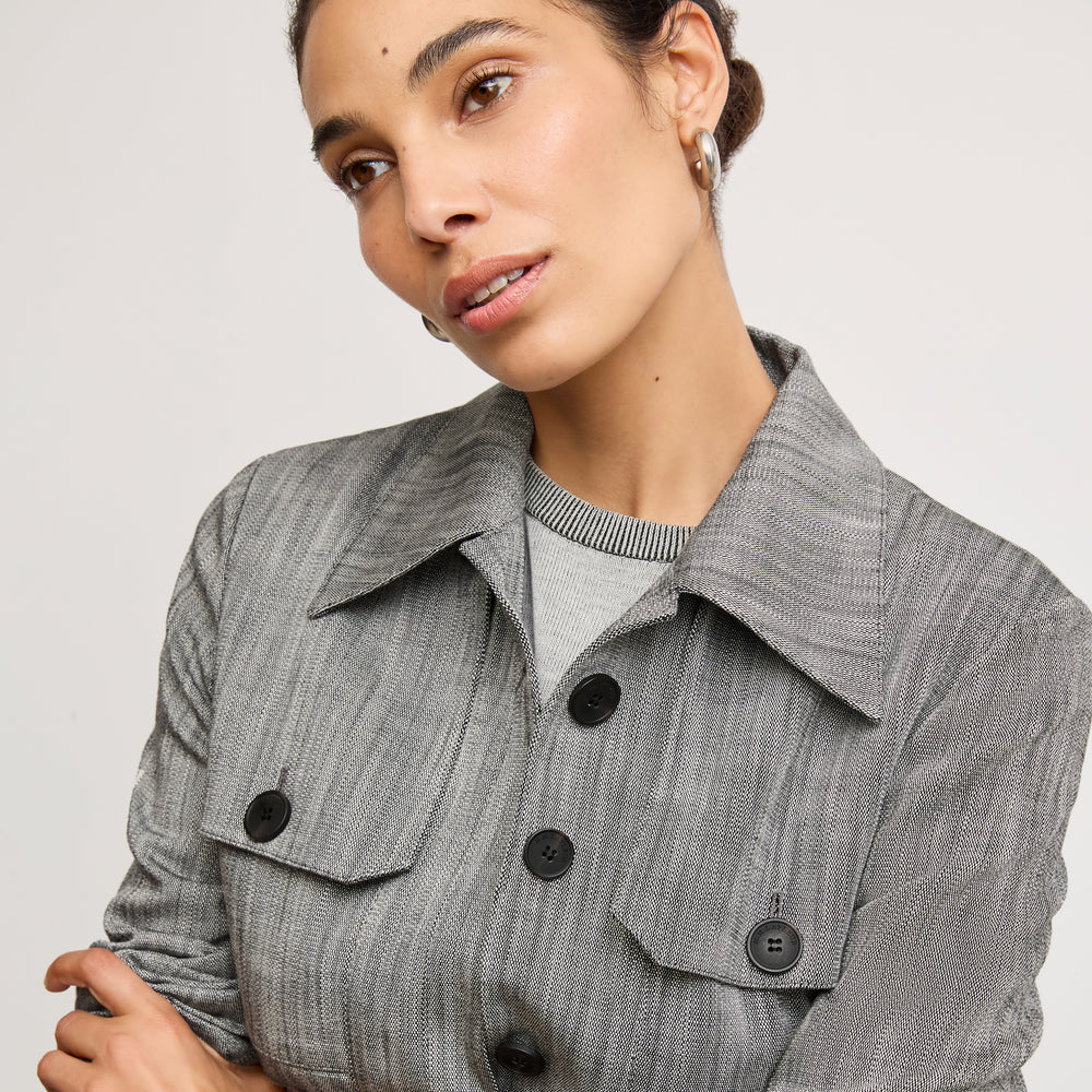 Front image of a woman wearing the emery jacket in Black/White Porto Weave