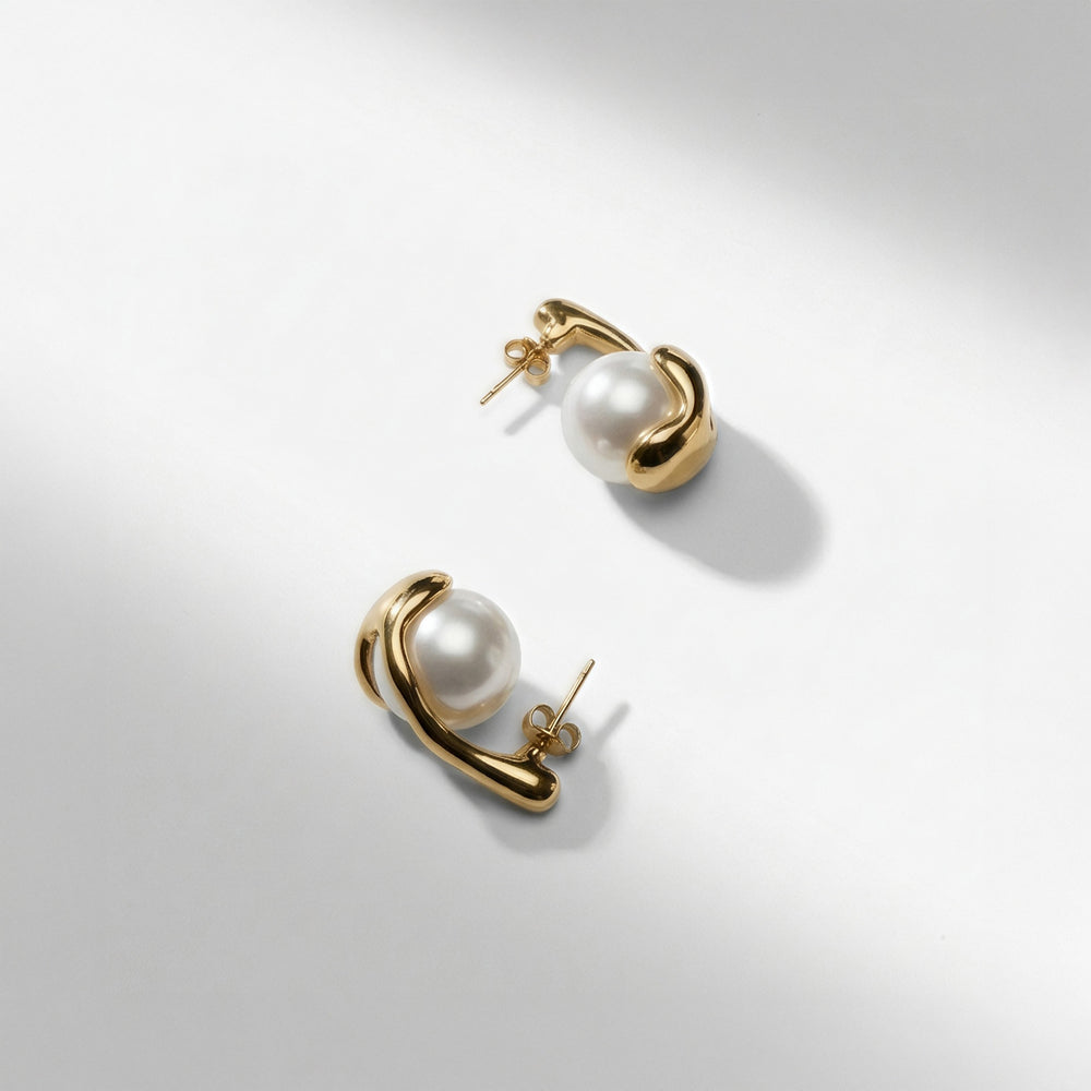 Pearl ball earring with gold wrapped around it