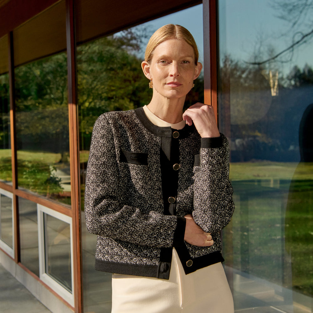 front image of a woman wearing the evangeline jacket in black/ivory