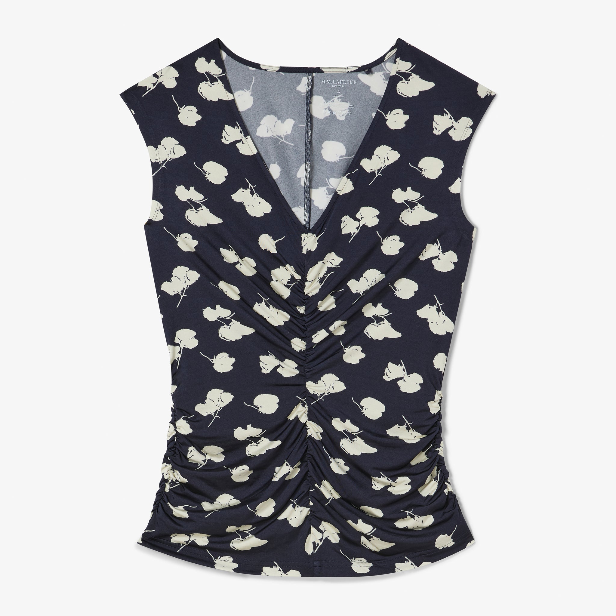 Navy sleeveless top with white floral pattern on a white background