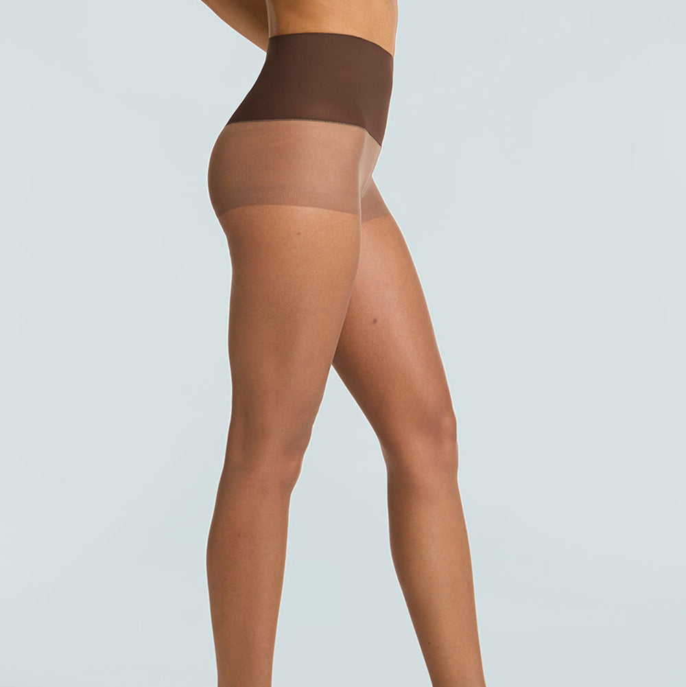 Brown sheer tights worn by a model on a light gray background