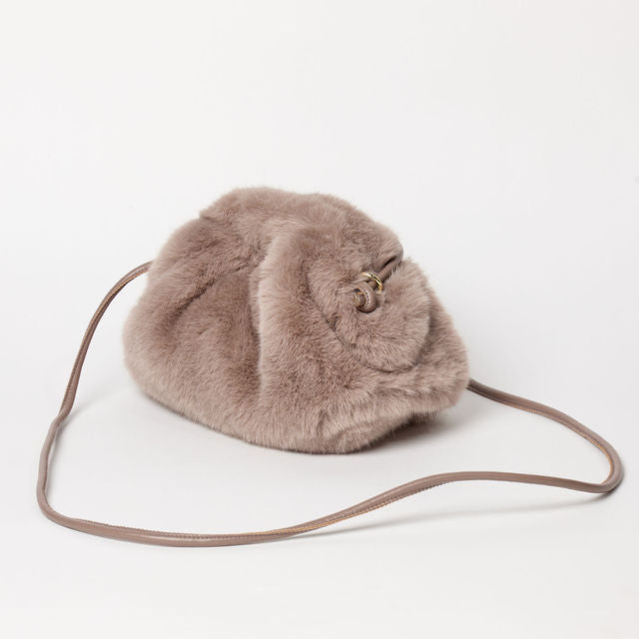 Furry bag with a strap on a white background