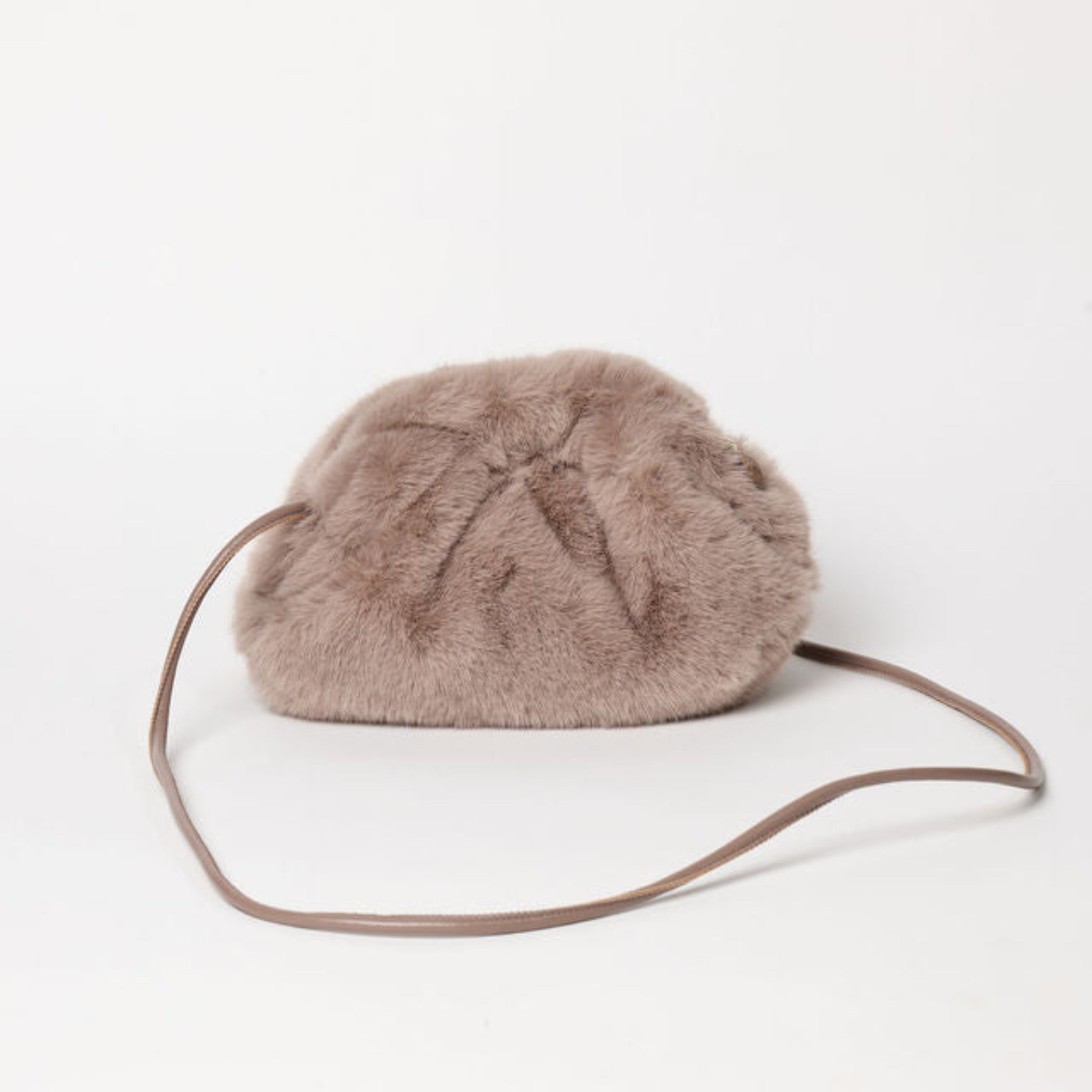 Brown fur bag with a strap on a white background 