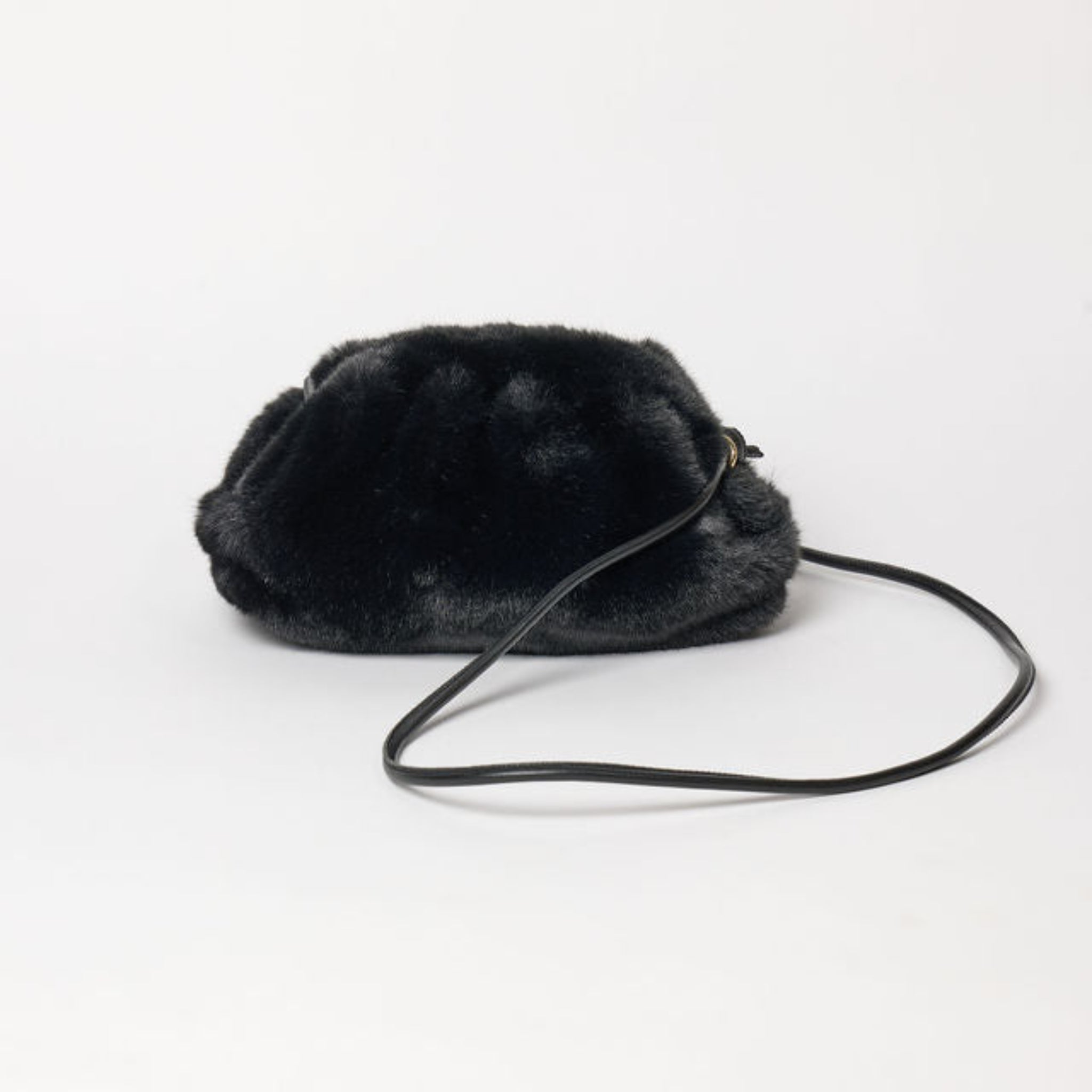 Black fur bag with a strap on a white background