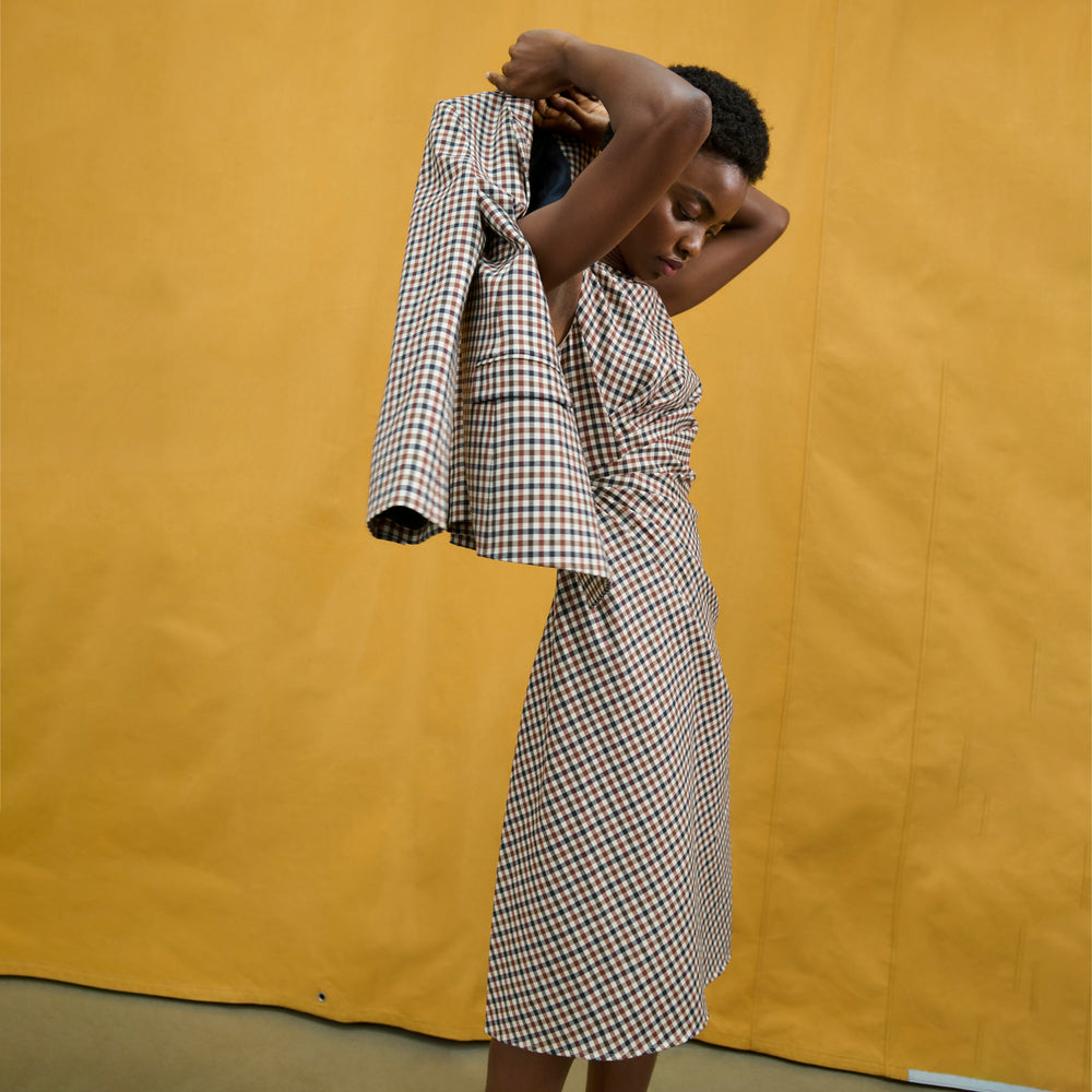 image of a woman wearing the jeannine dress in windowpane sharkskin