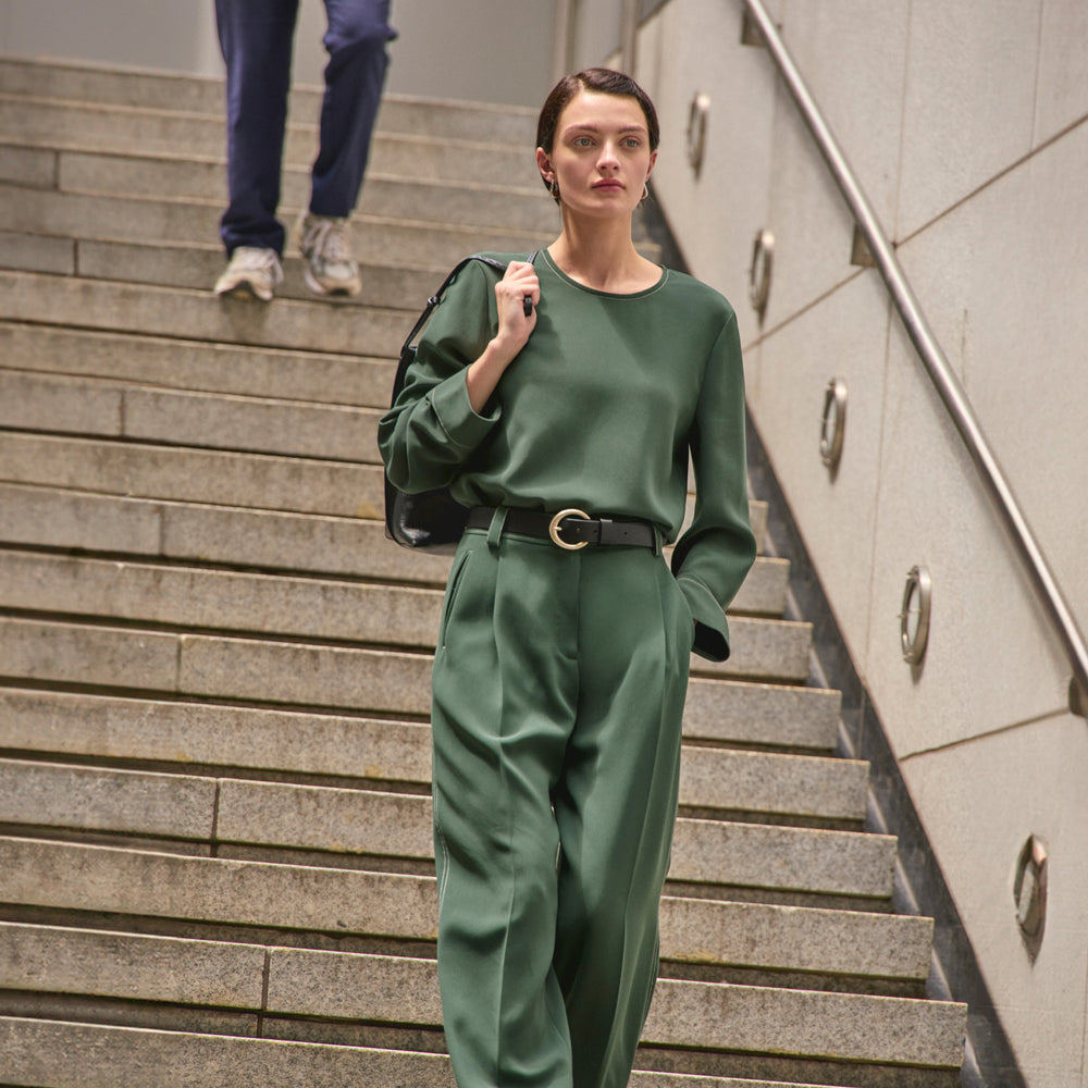 image of a woman wearing the jules top in dusty pine